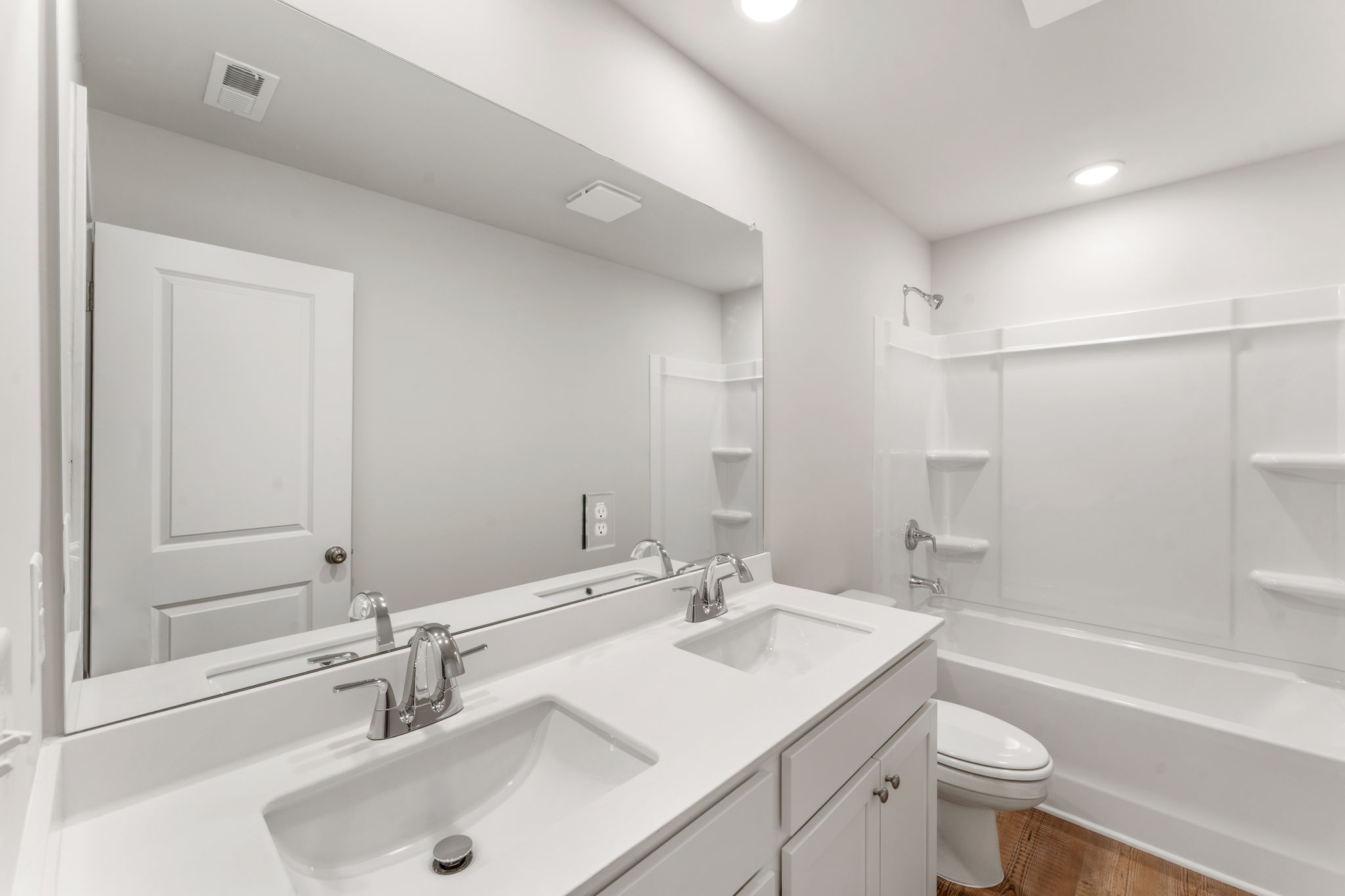 A bathroom with a tub sink and toilet.