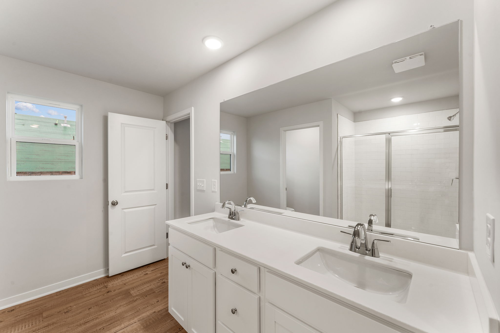 A bathroom with a large mirror.