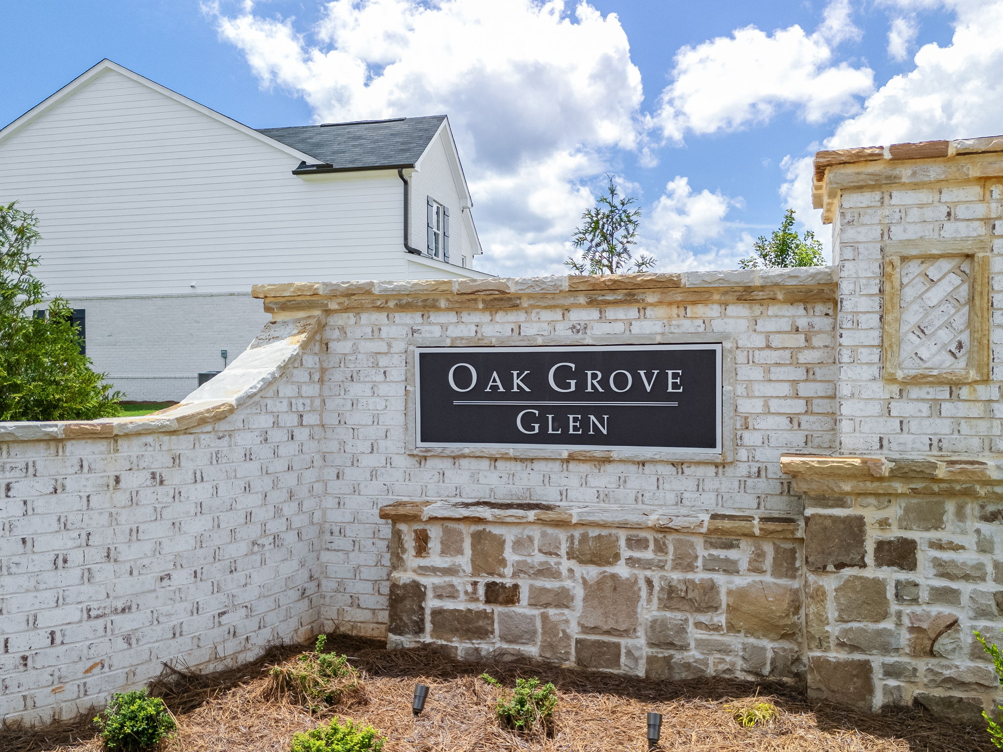 A sign on a stone wall.