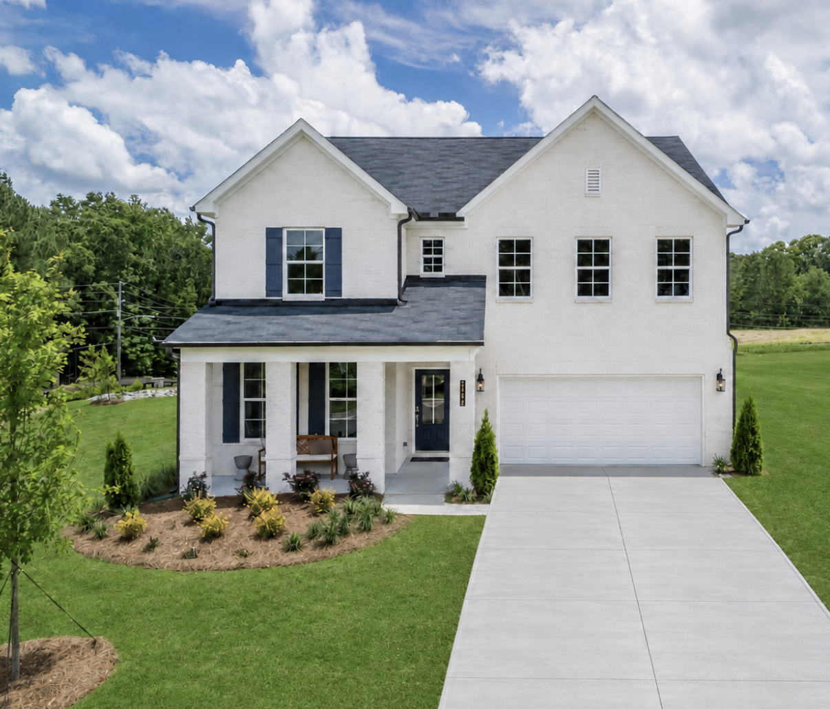 A white house with a driveway.