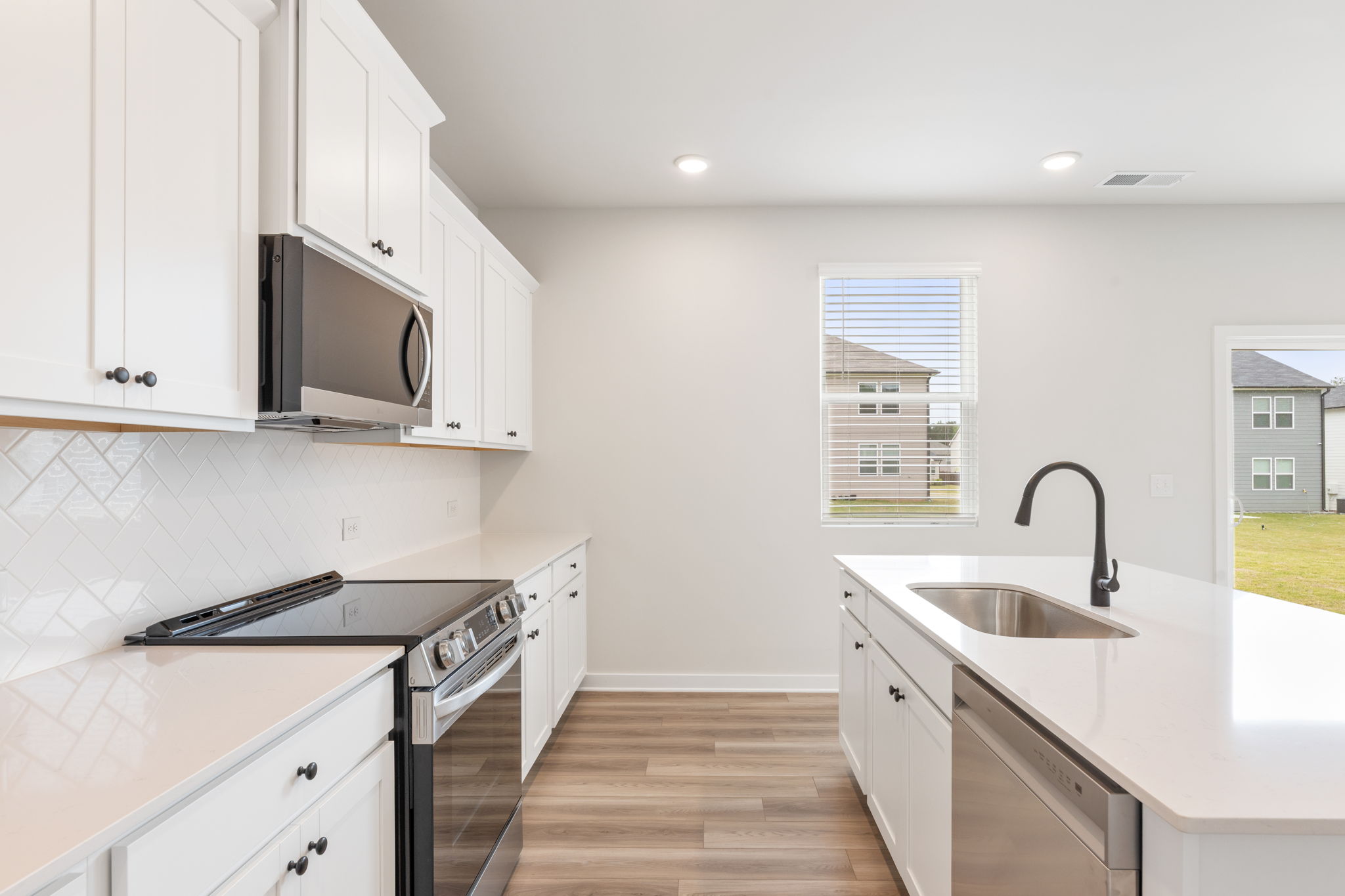 A kitchen with white cabinets.