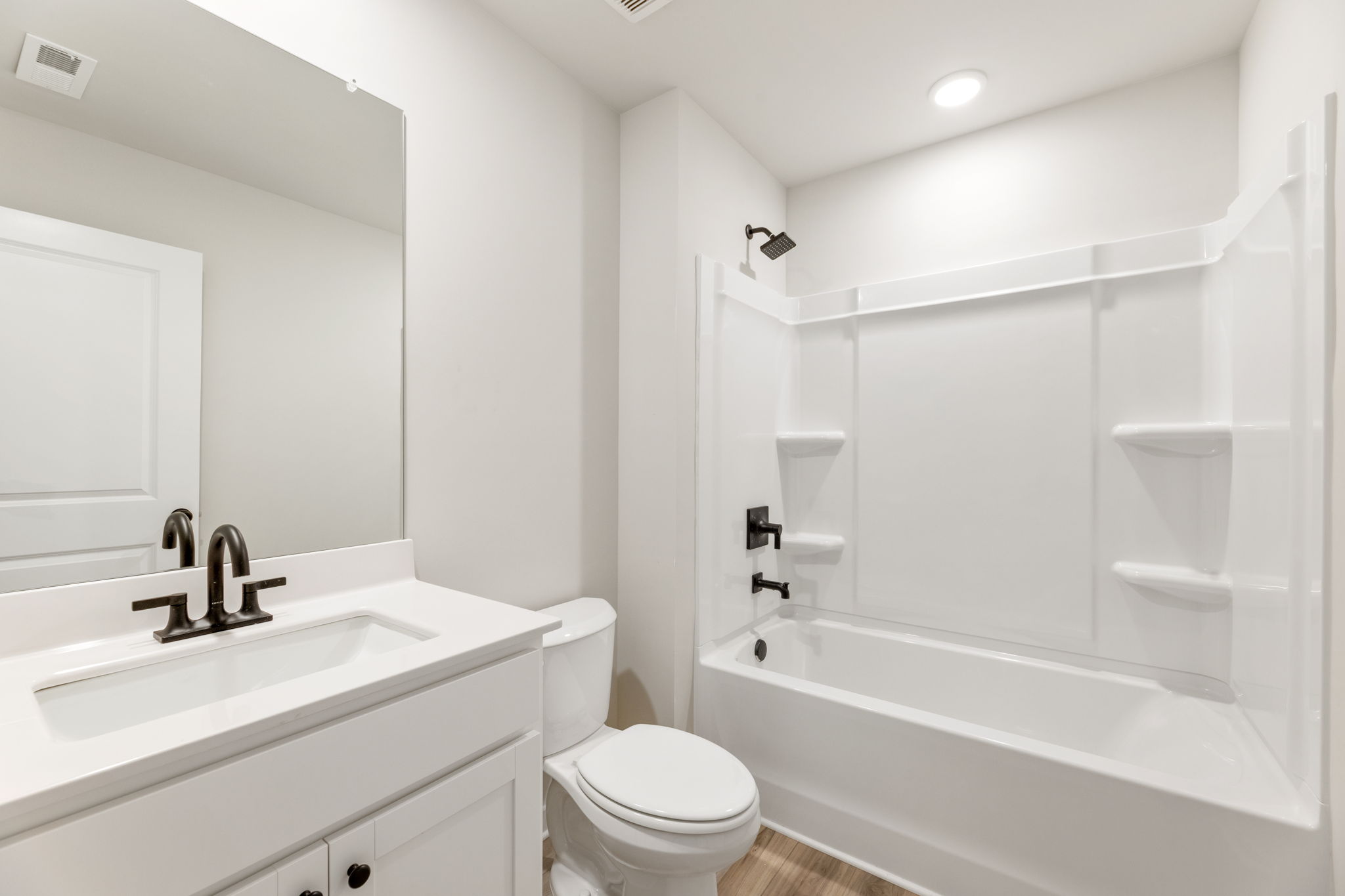 A bathroom with a tub toilet and sink.