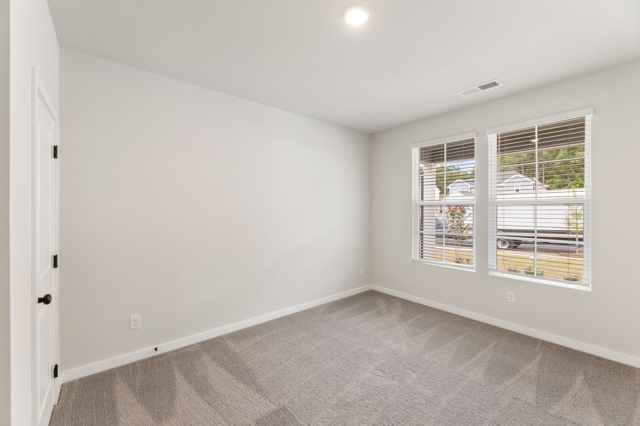 A room with a window and a door.