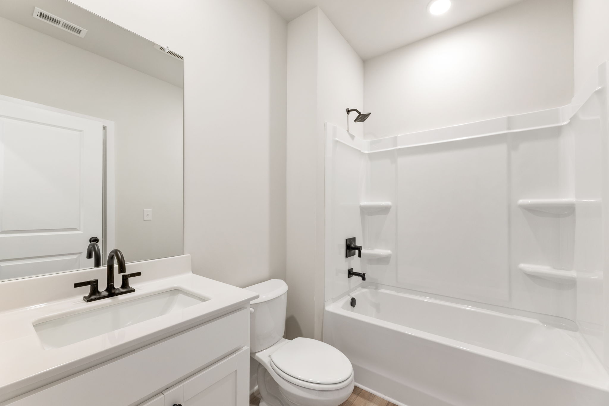 A bathroom with a tub toilet and sink.