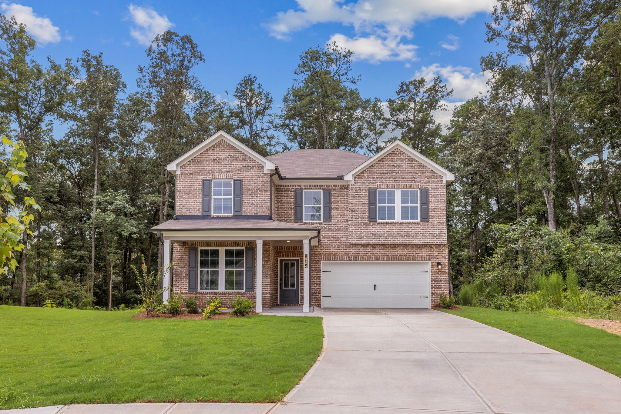 A house with a driveway and trees.