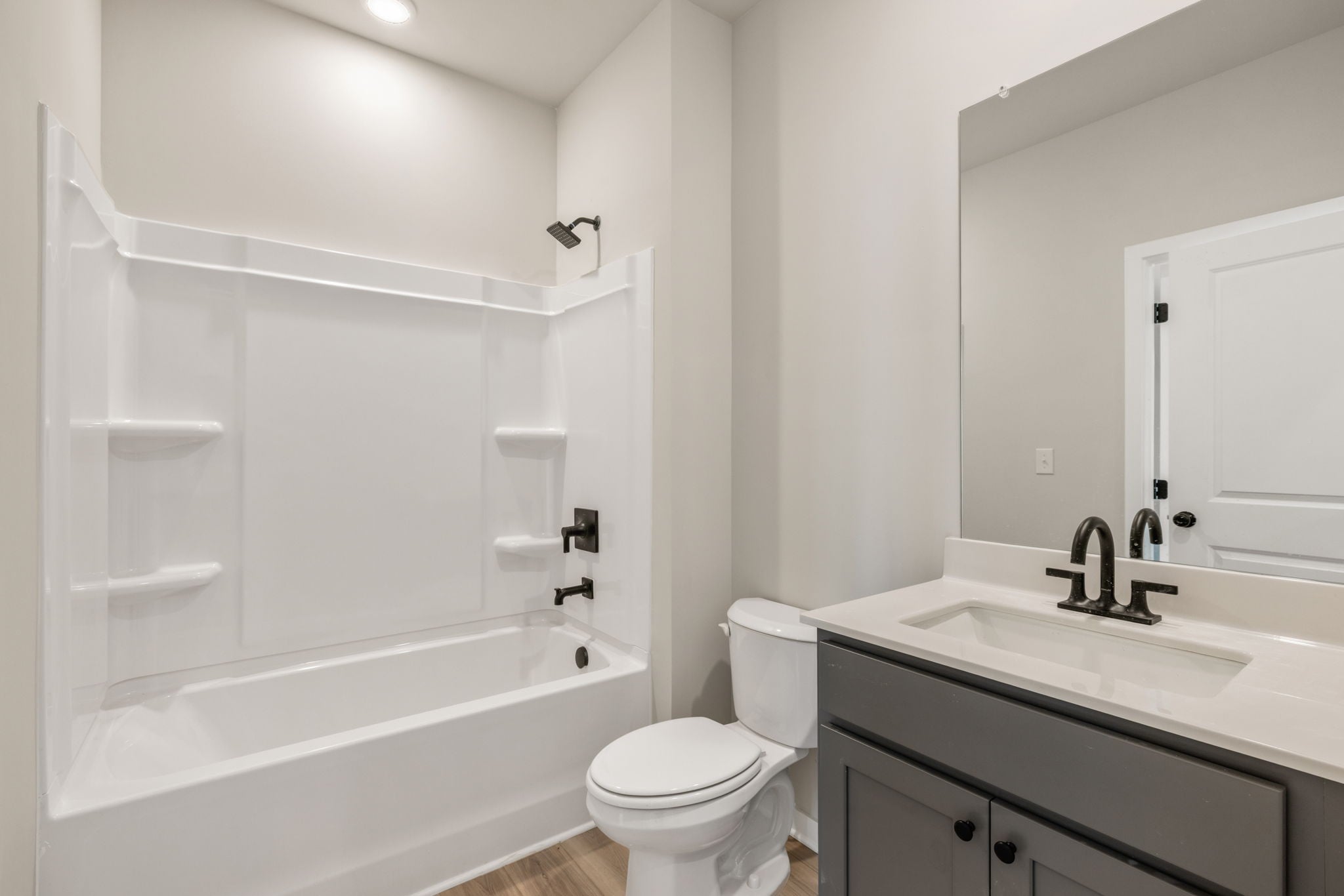 A bathroom with a tub sink and toilet.