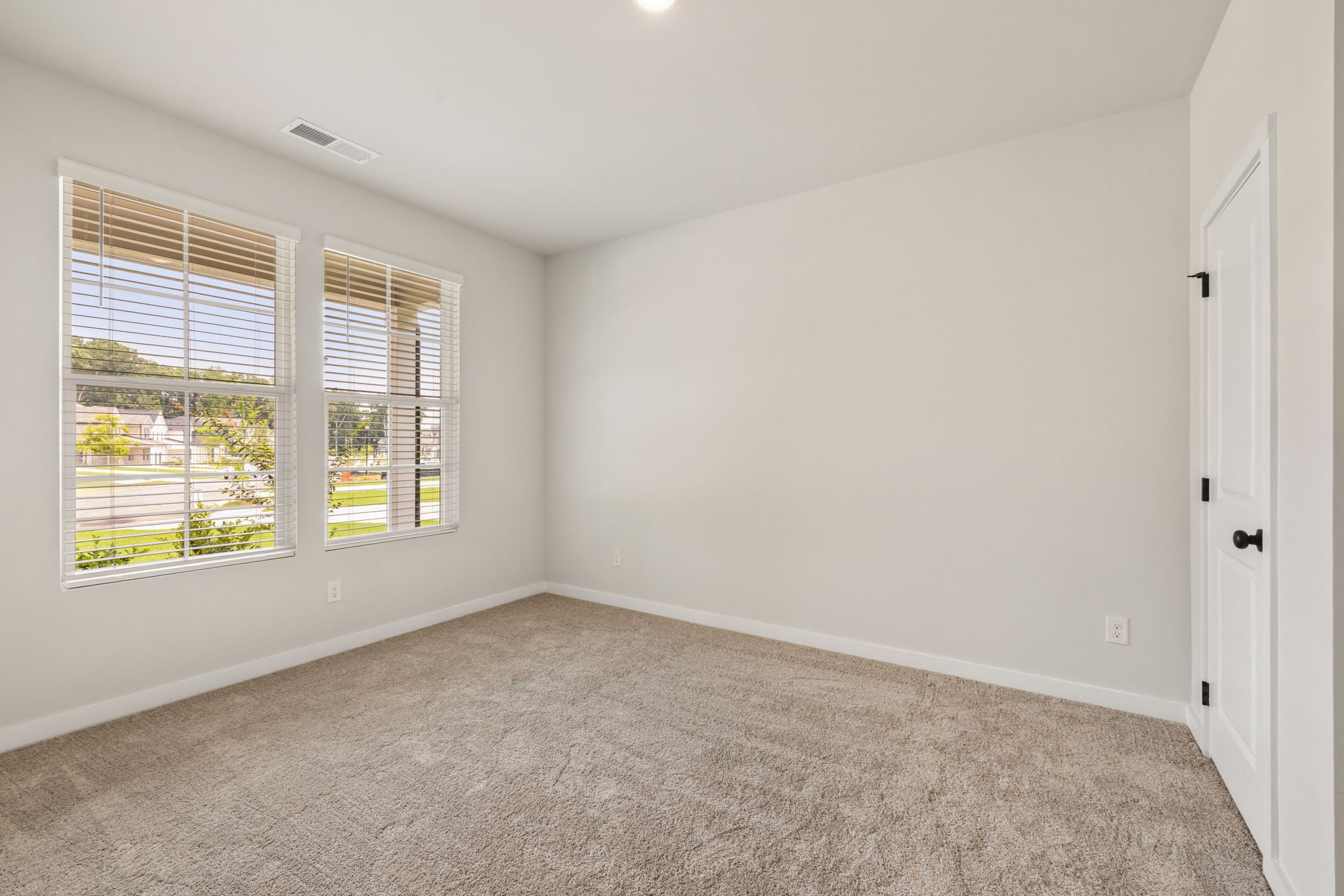 A room with a window and a door.