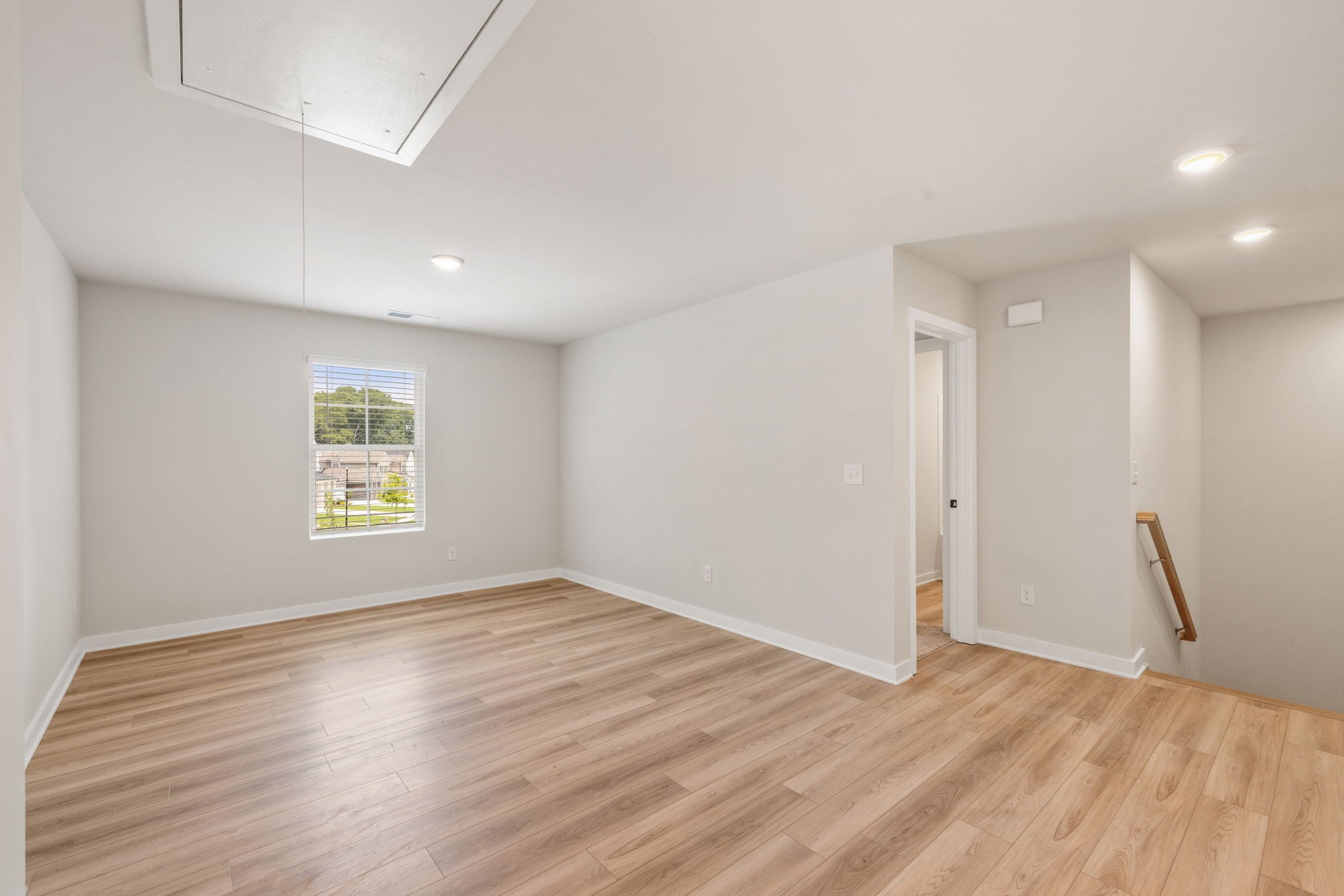 A room with a wood floor and a wood floor.