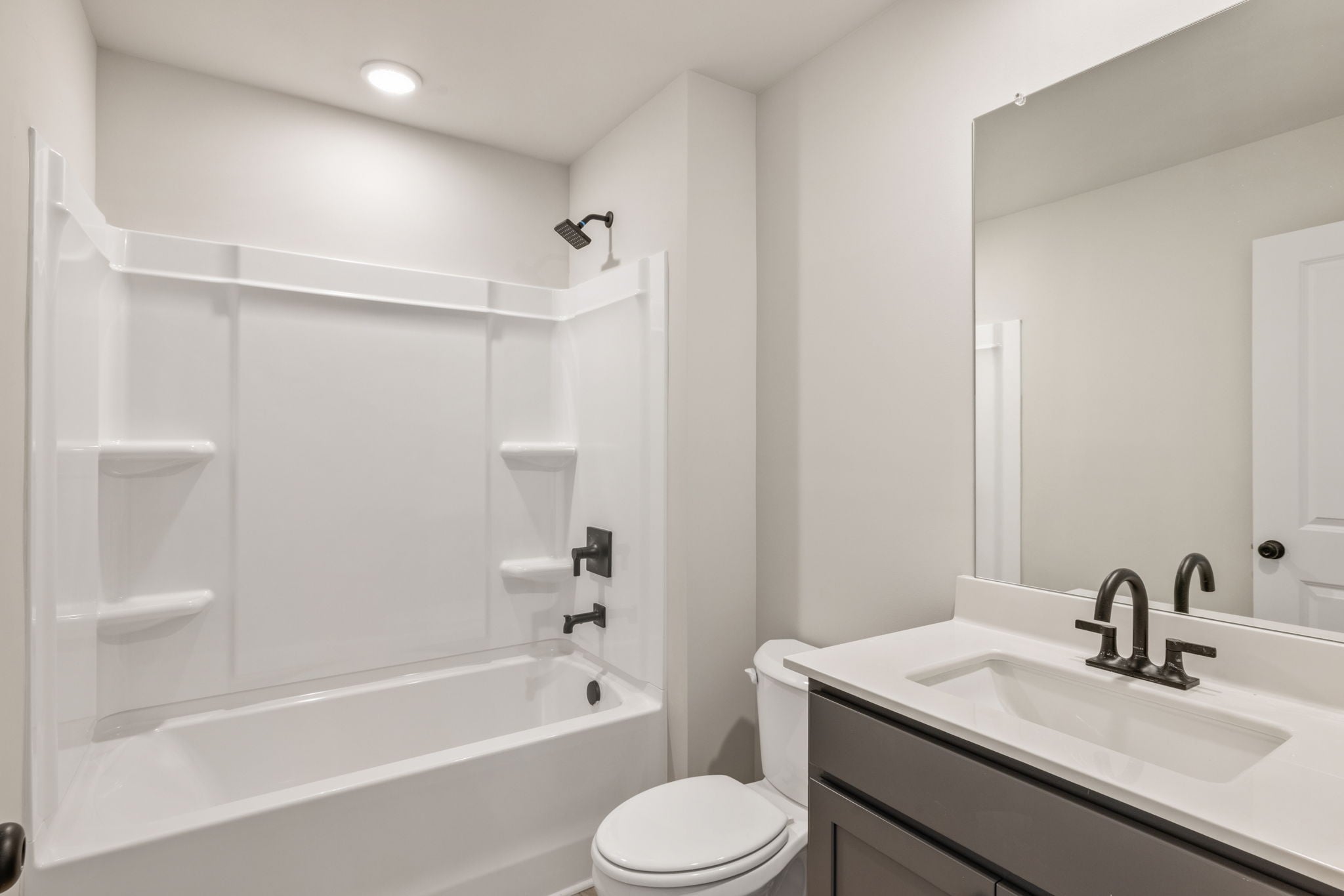 A bathroom with a tub sink and toilet.