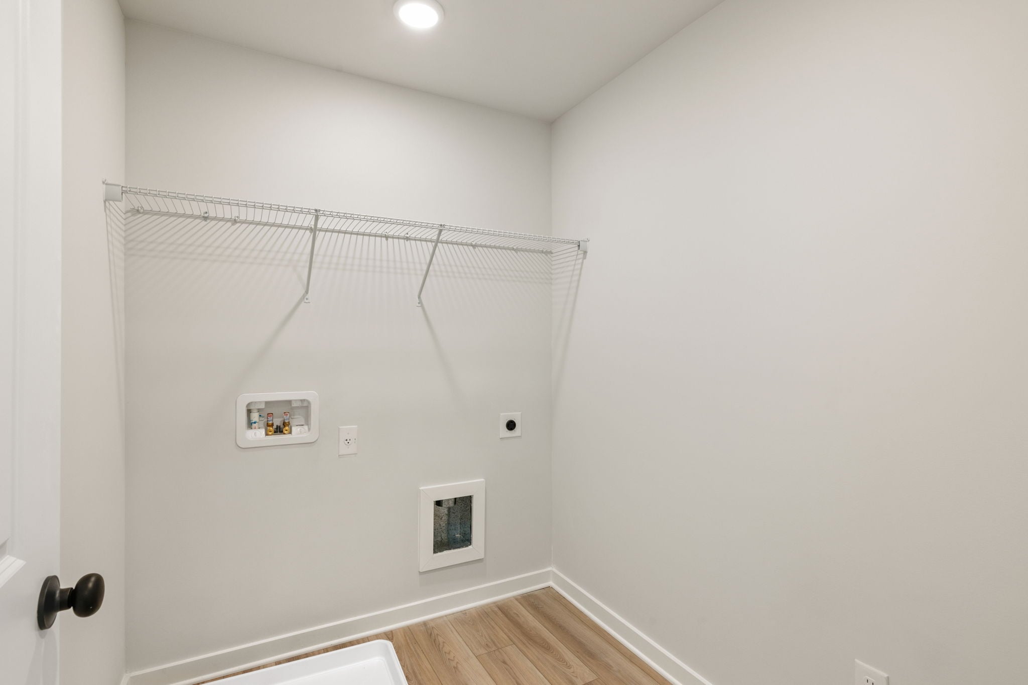 A white room with a wood floor.