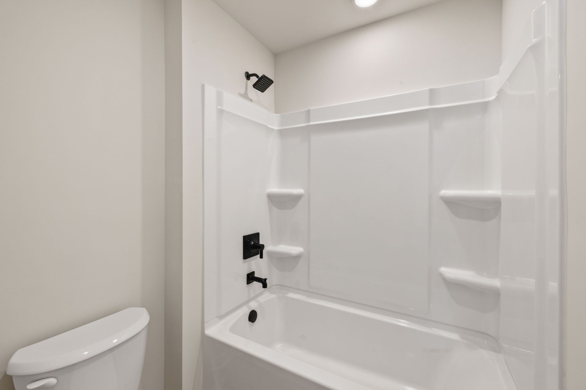 A bathroom with a bathtub and toilet.