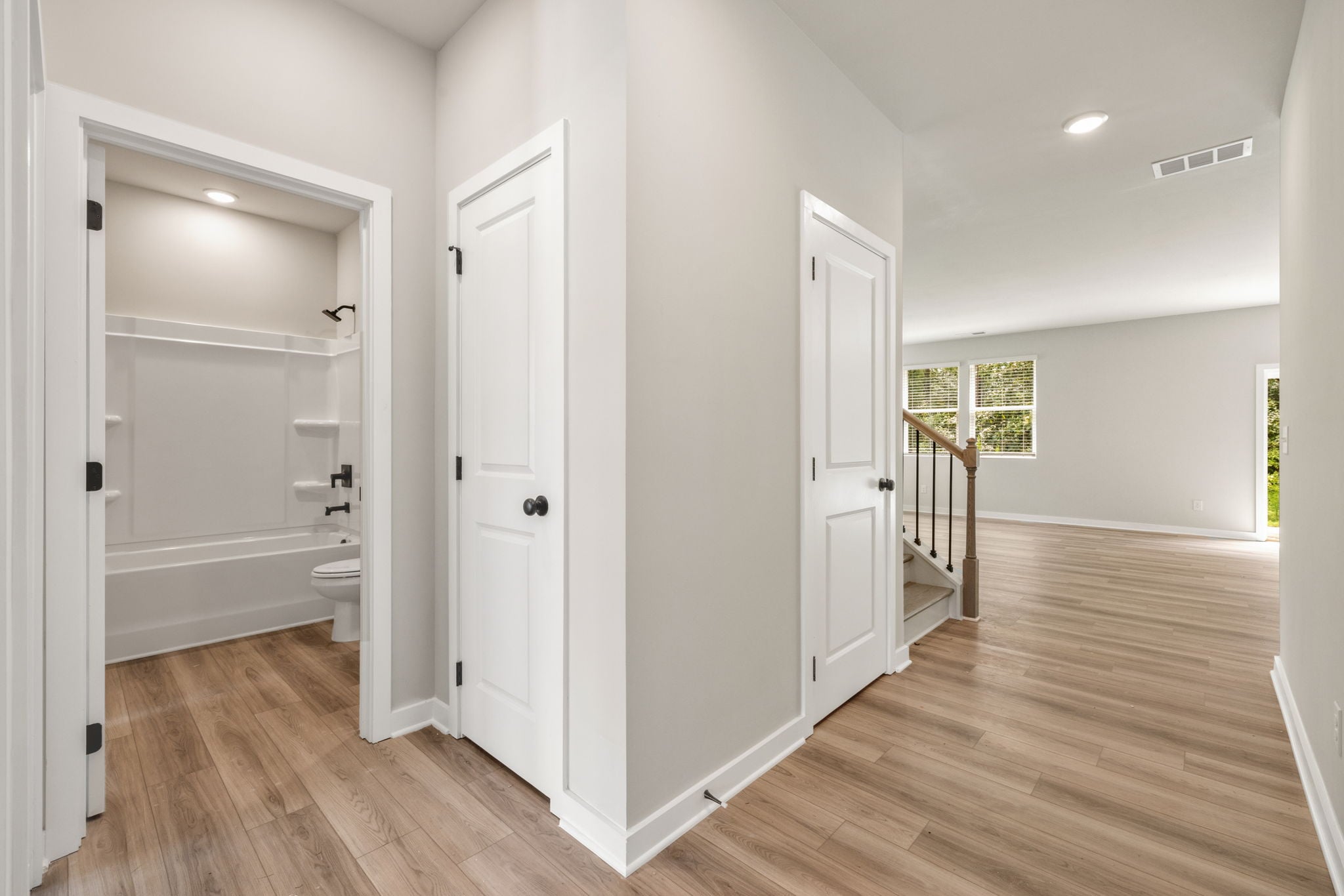 A bathroom with white doors.