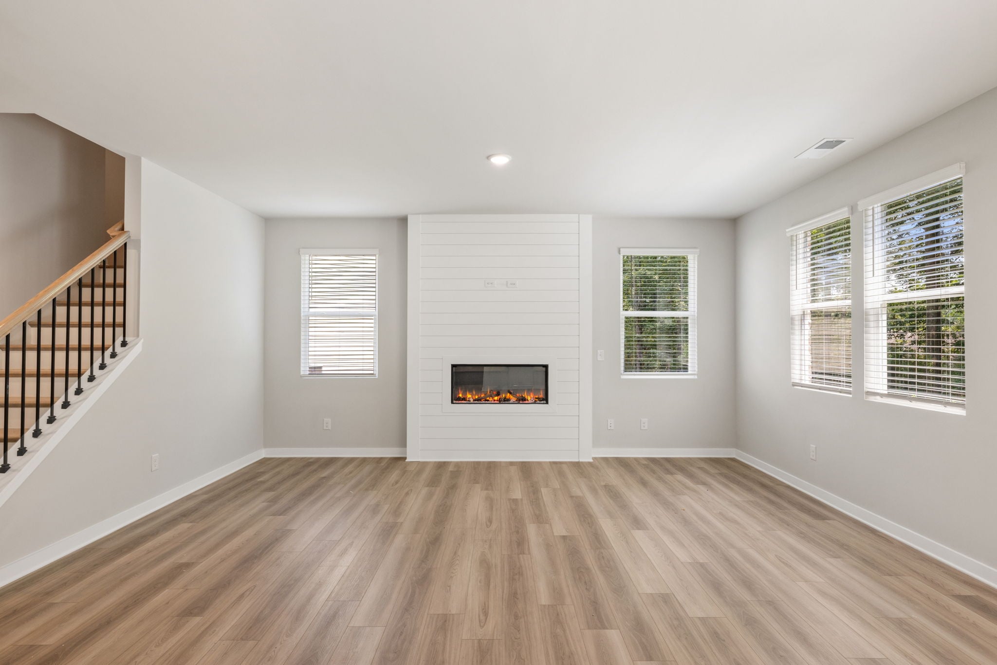A room with a fireplace and windows.