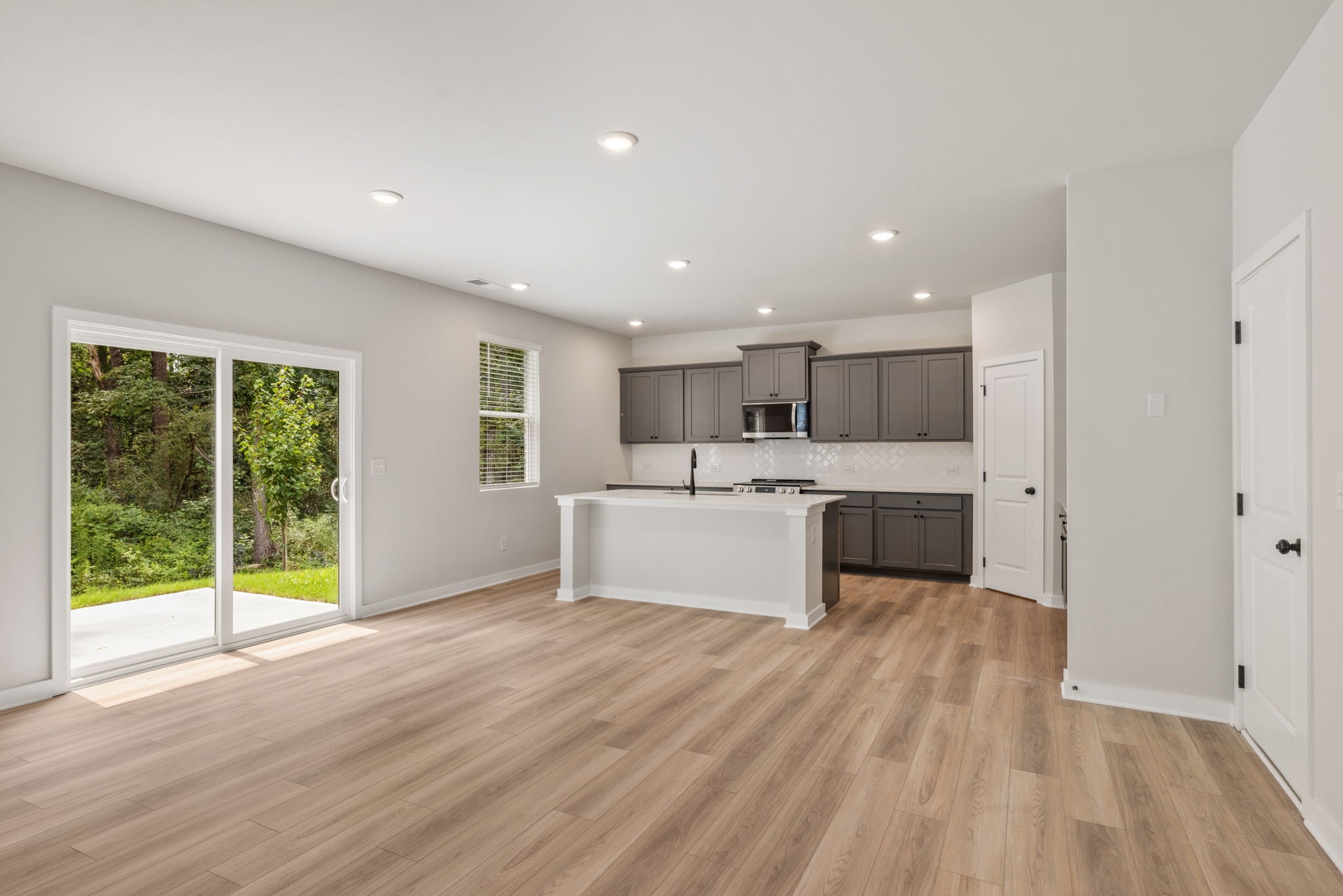 A kitchen with white cabinets.
