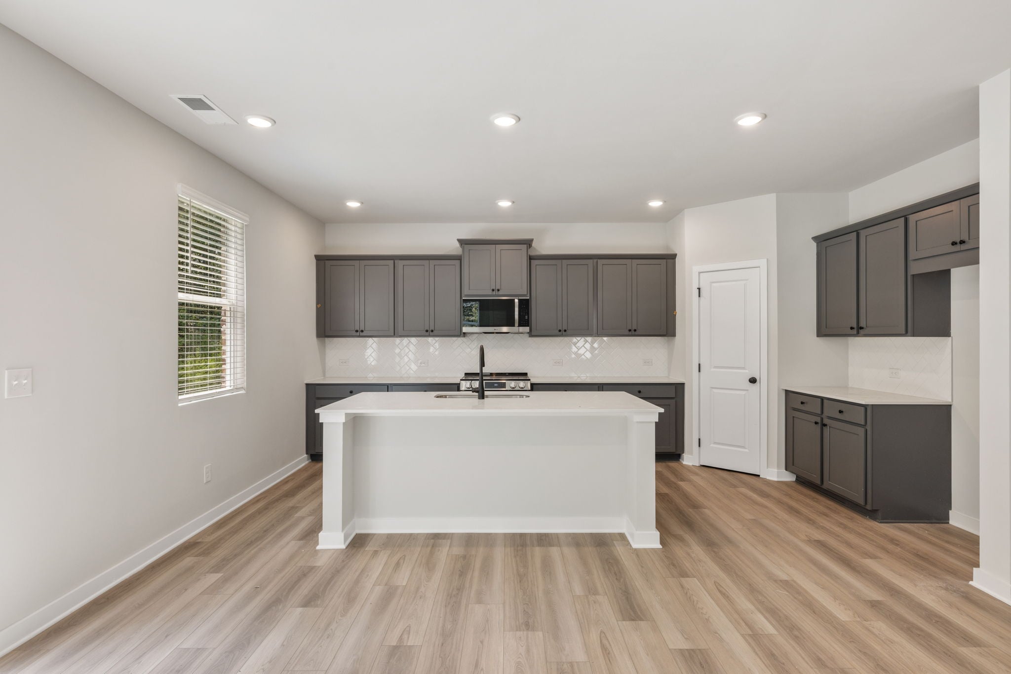 A kitchen with black cabinets.