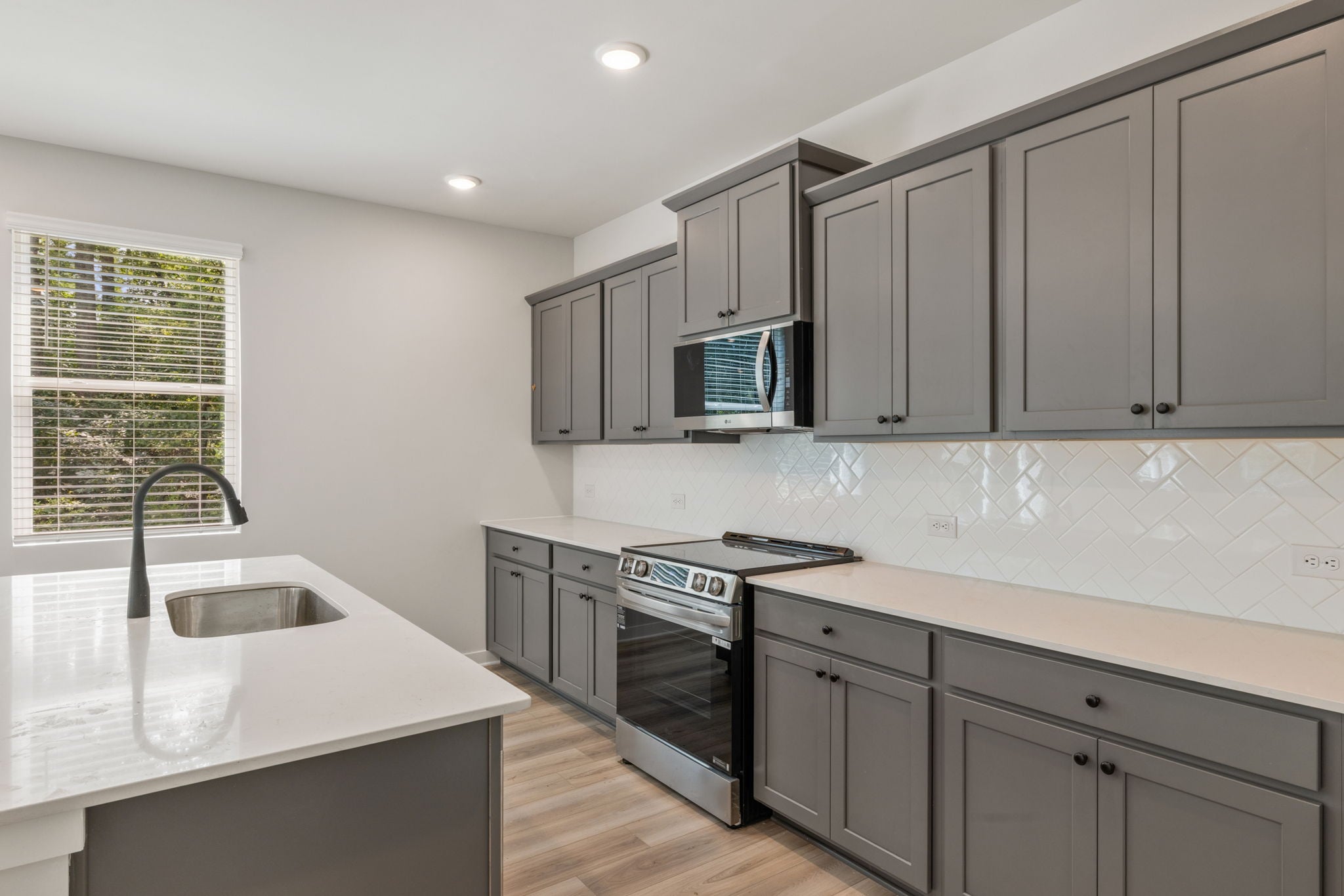 A kitchen with white cabinets.