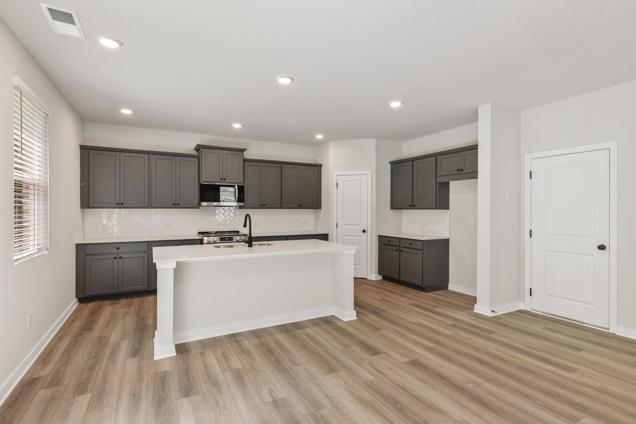A kitchen with black cabinets.