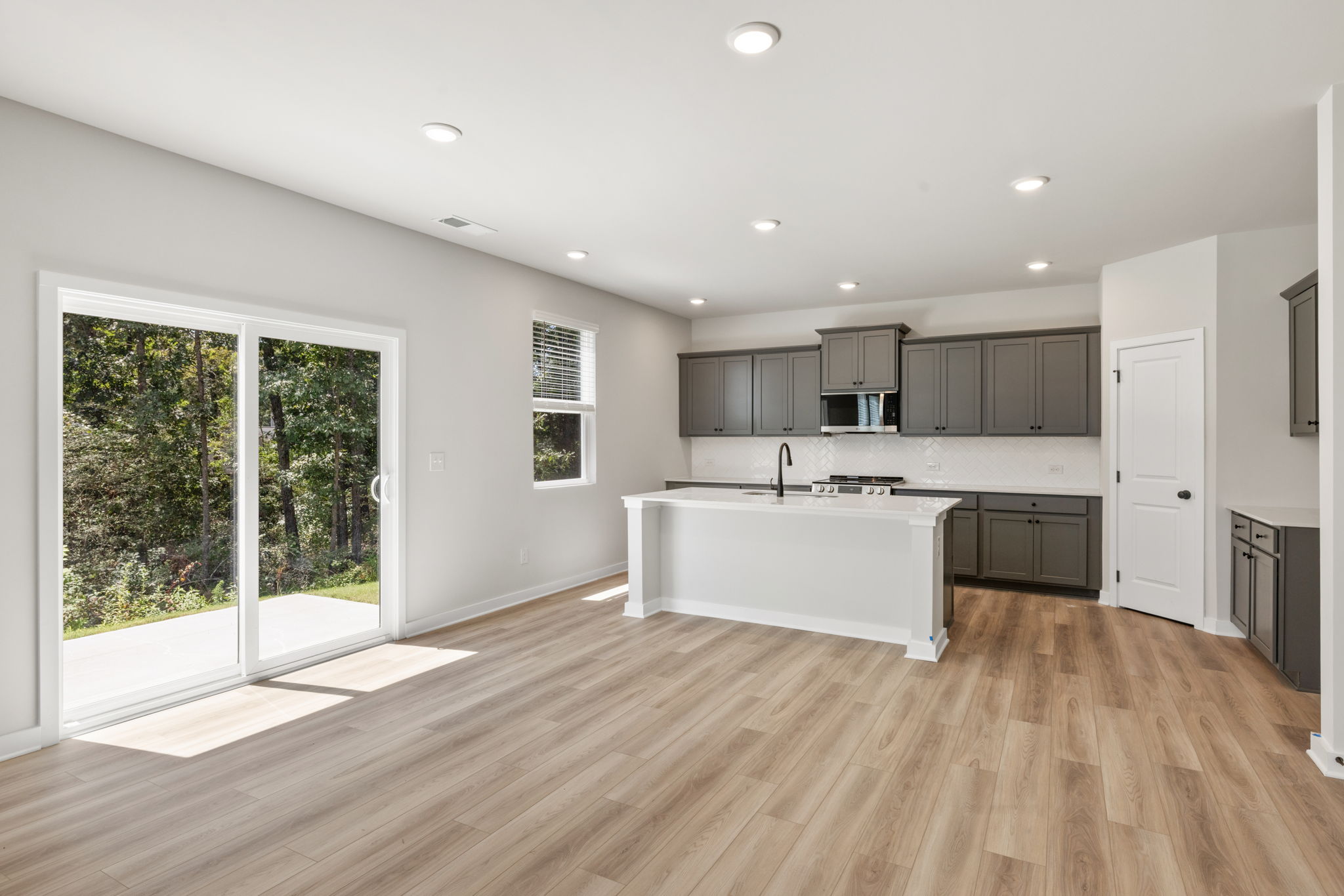 A kitchen with a wood floor.