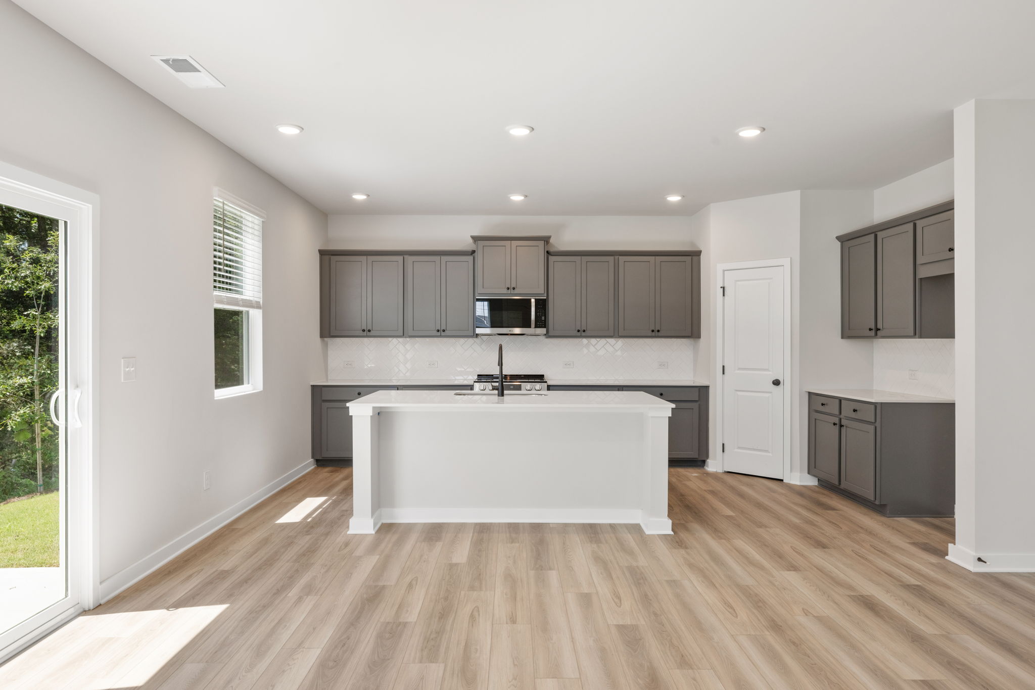 A kitchen with a white counter top.