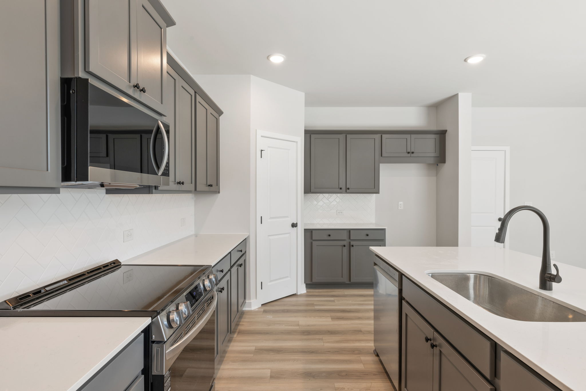 A kitchen with white cabinets.