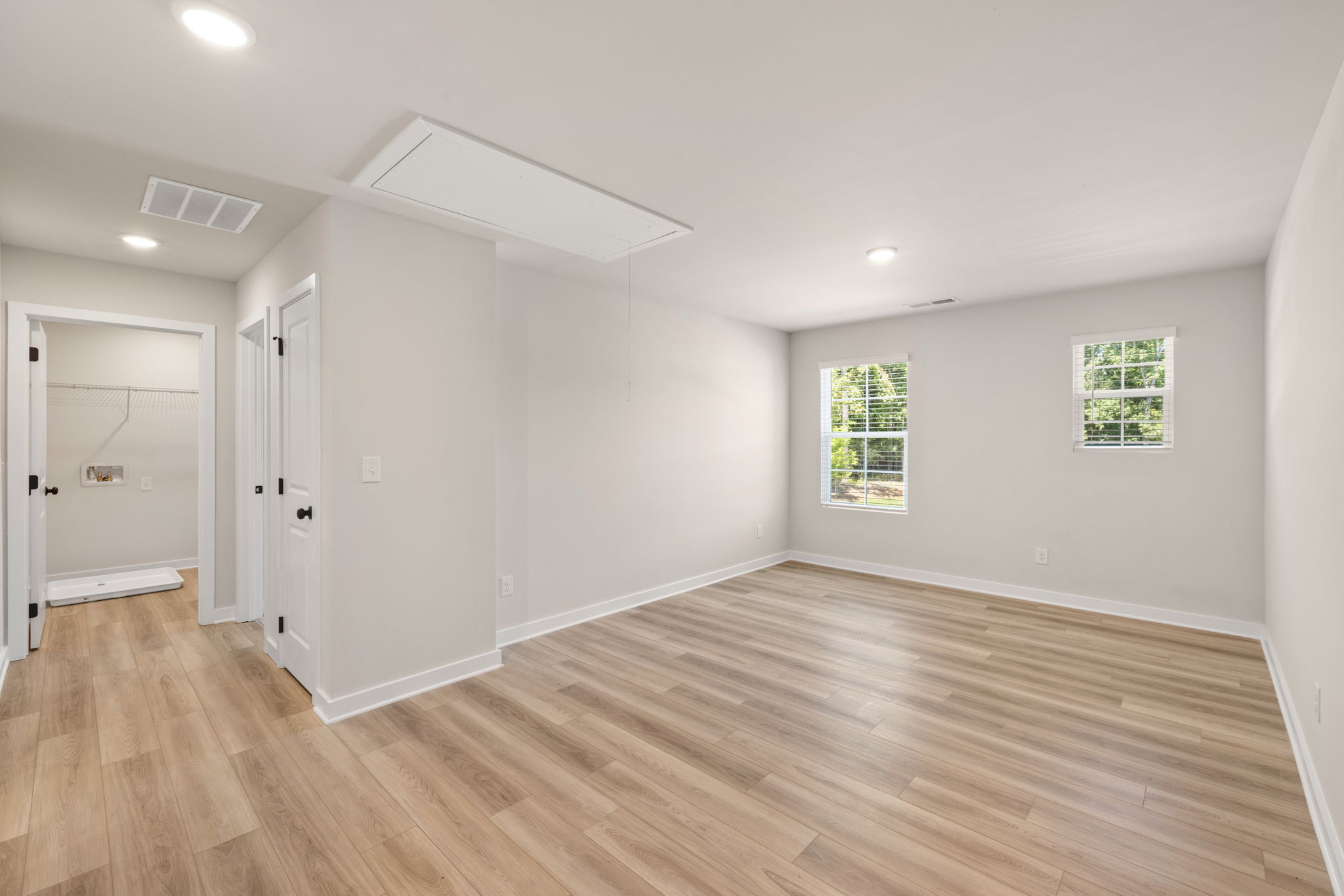 A room with a wood floor and white walls.