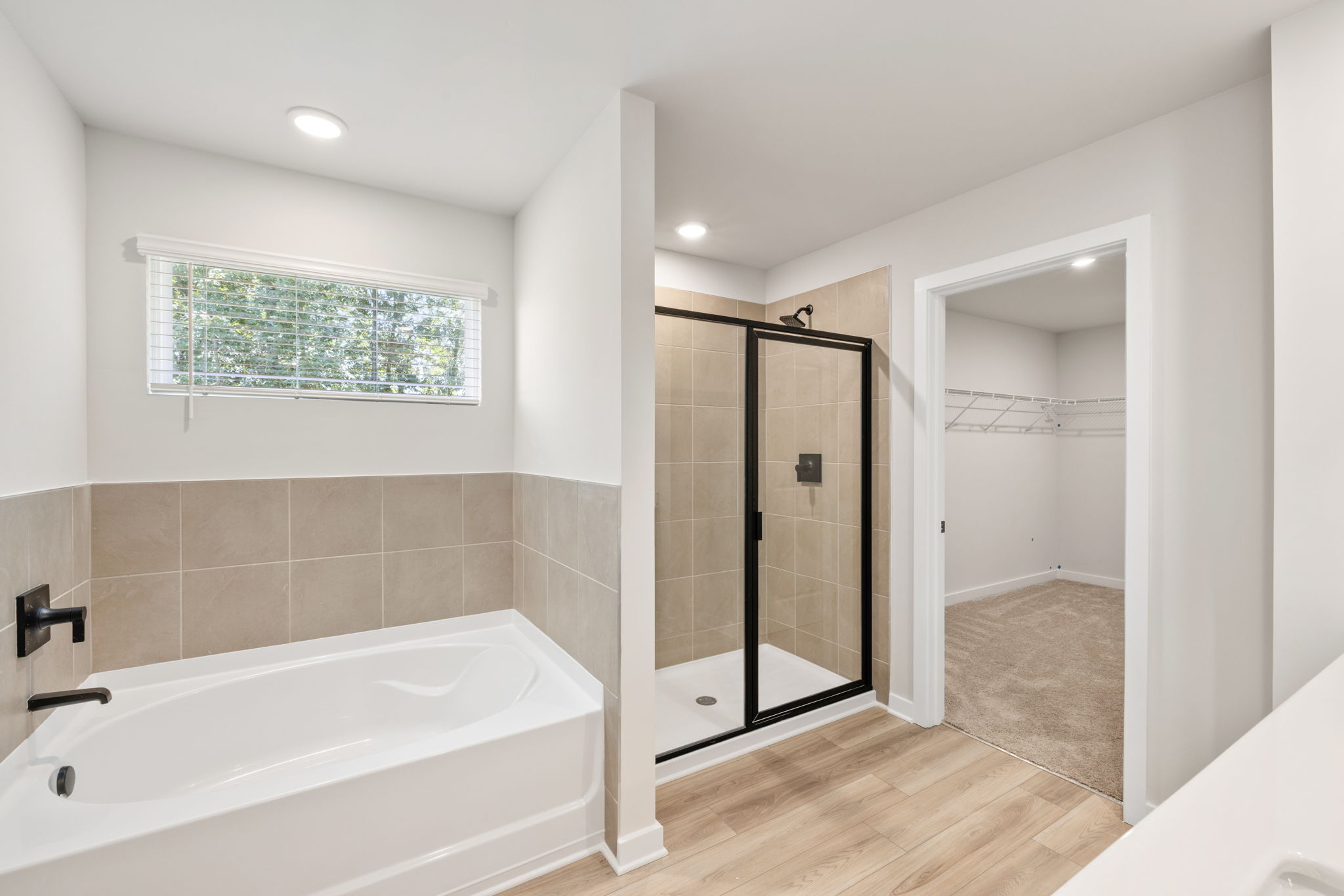 A bathroom with a tub and shower.