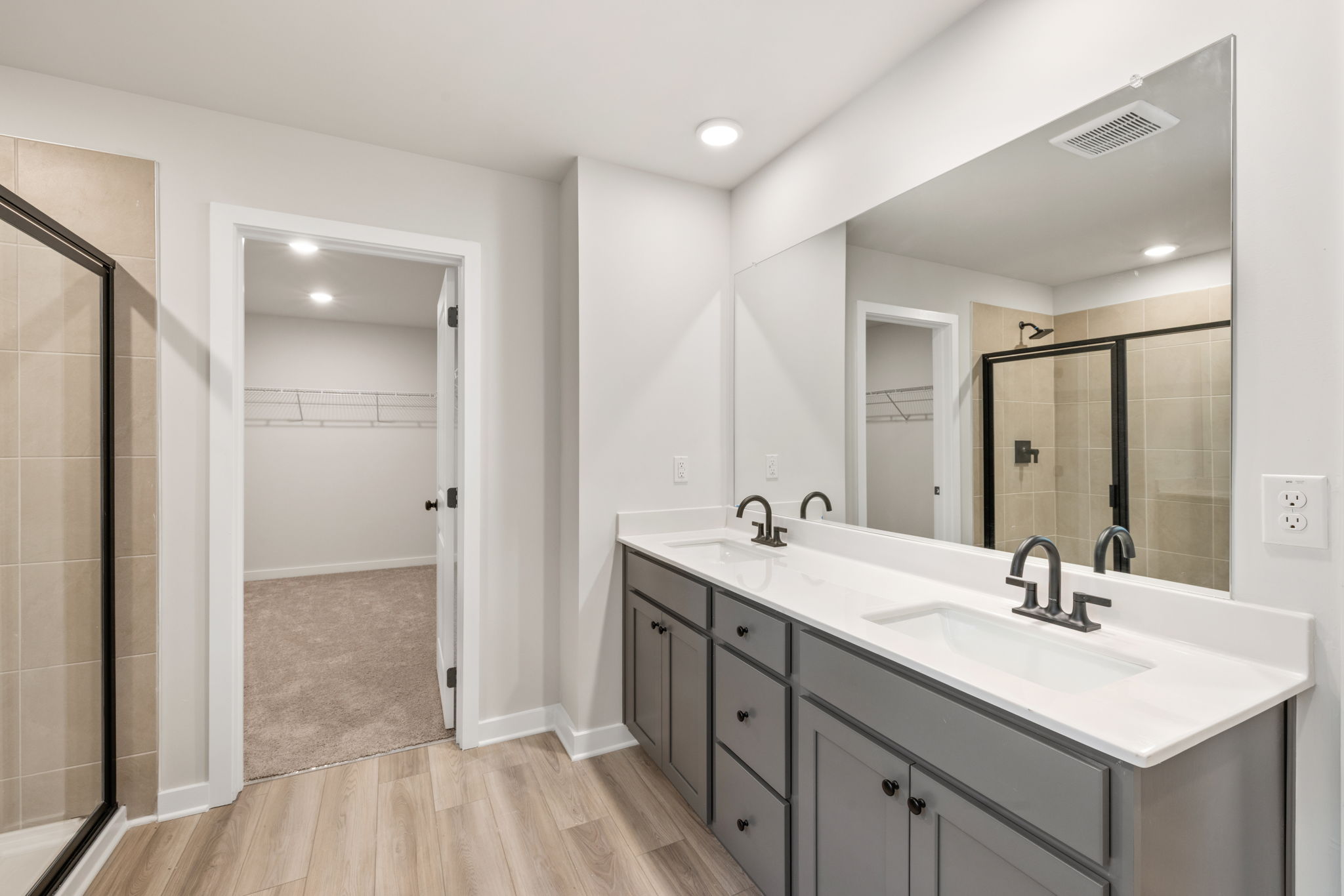 A bathroom with a large mirror.