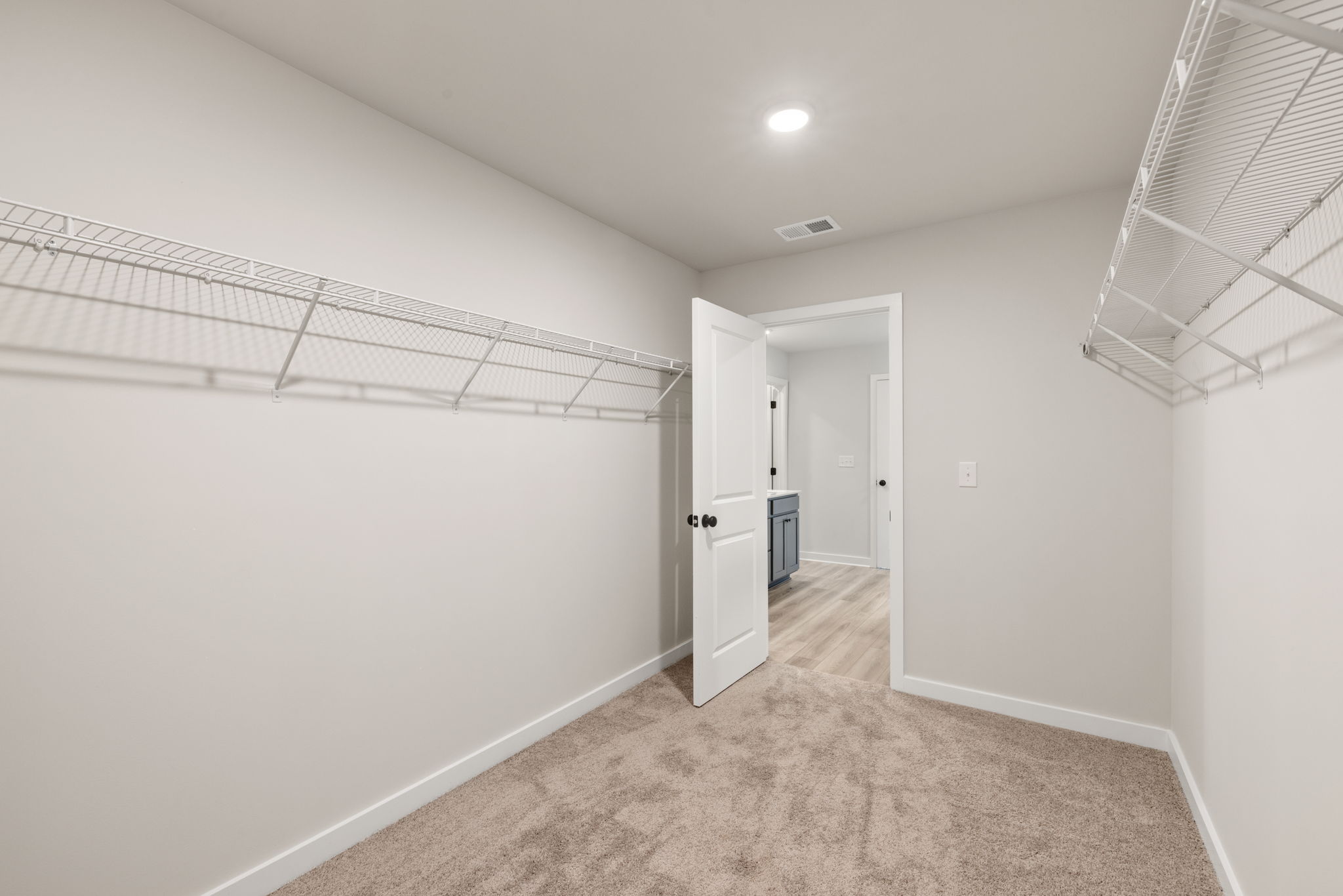 A hallway with white walls.