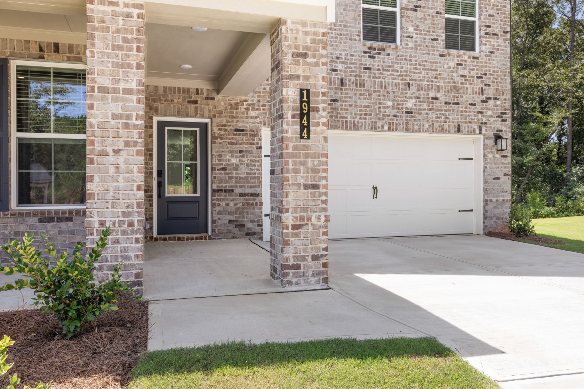 A brick building with a garage door.