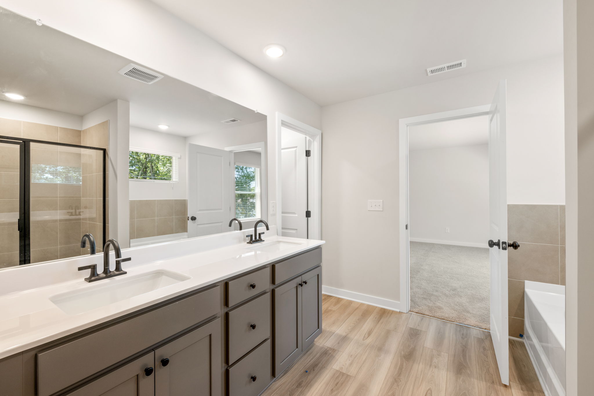 A bathroom with a tub sink and a shower.