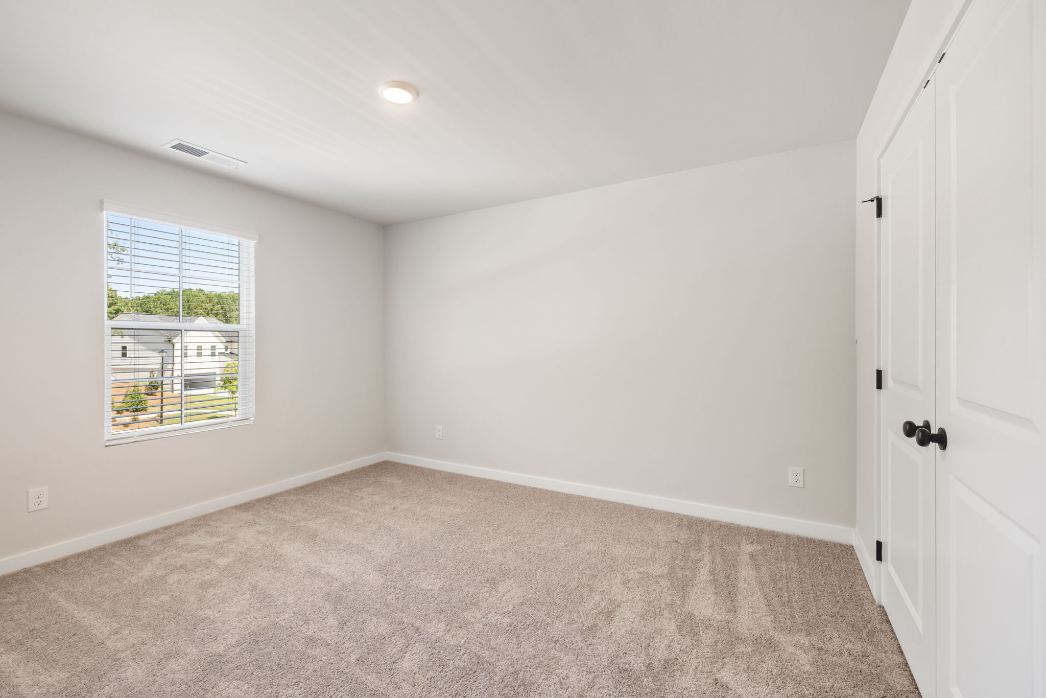 A room with a window and a door.