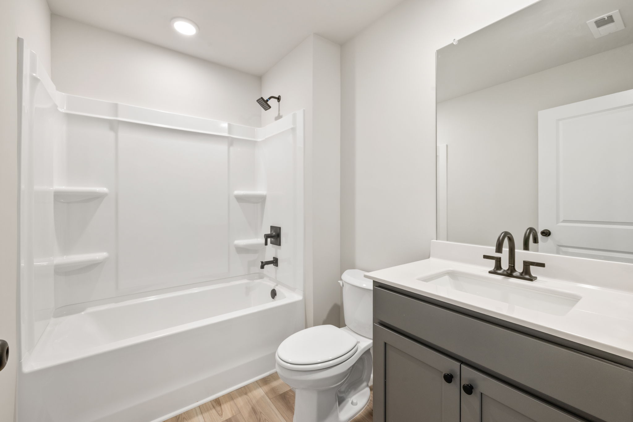 A bathroom with a tub sink and toilet.