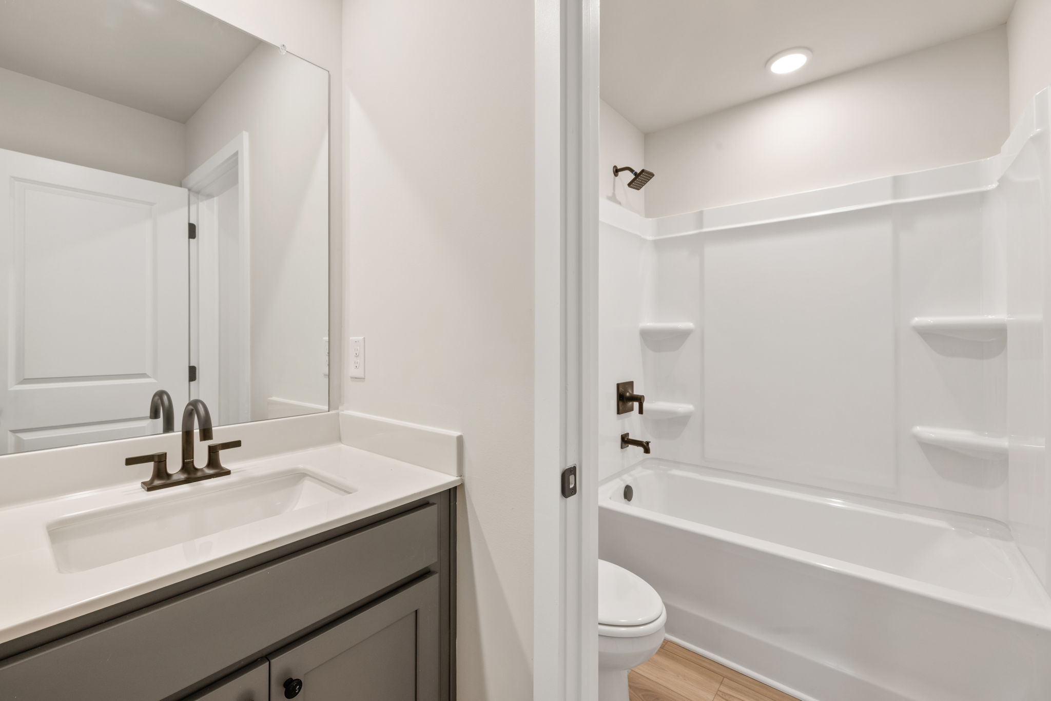 A bathroom with a tub sink and toilet.
