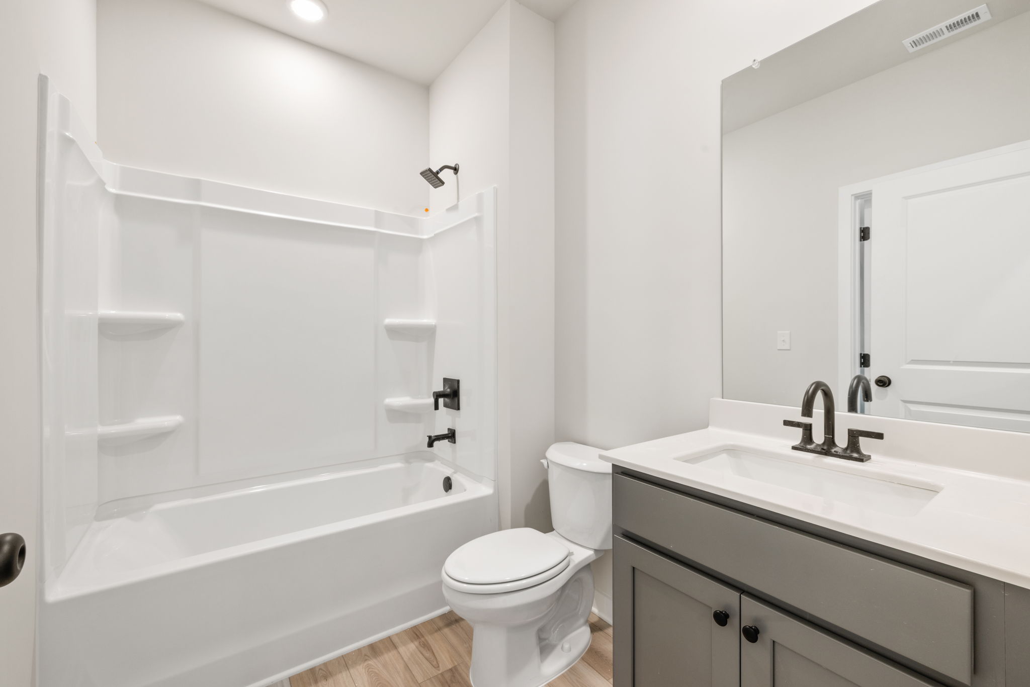 A bathroom with a tub sink and toilet.