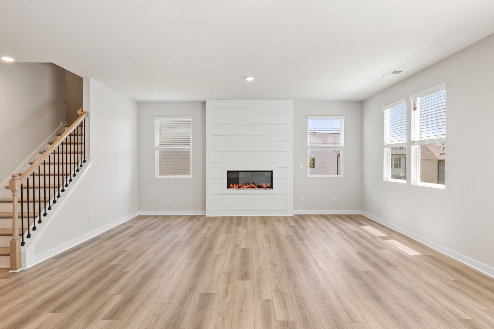 A room with a fireplace and a wood floor.