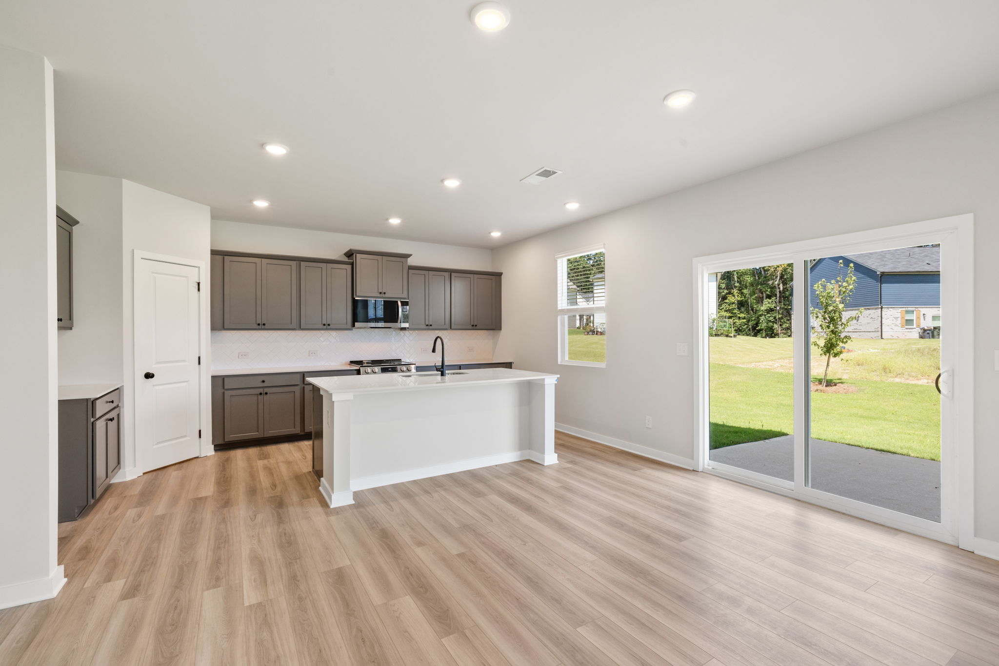 A kitchen with a large glass door.