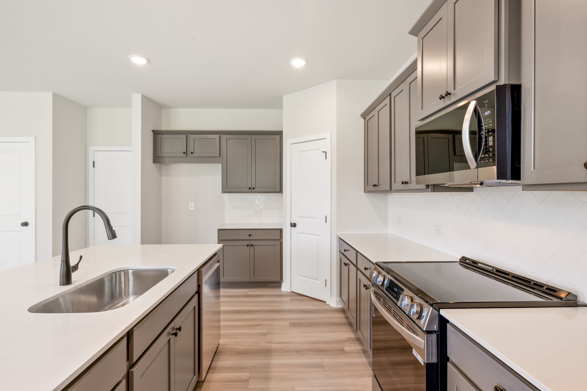 A kitchen with white cabinets.