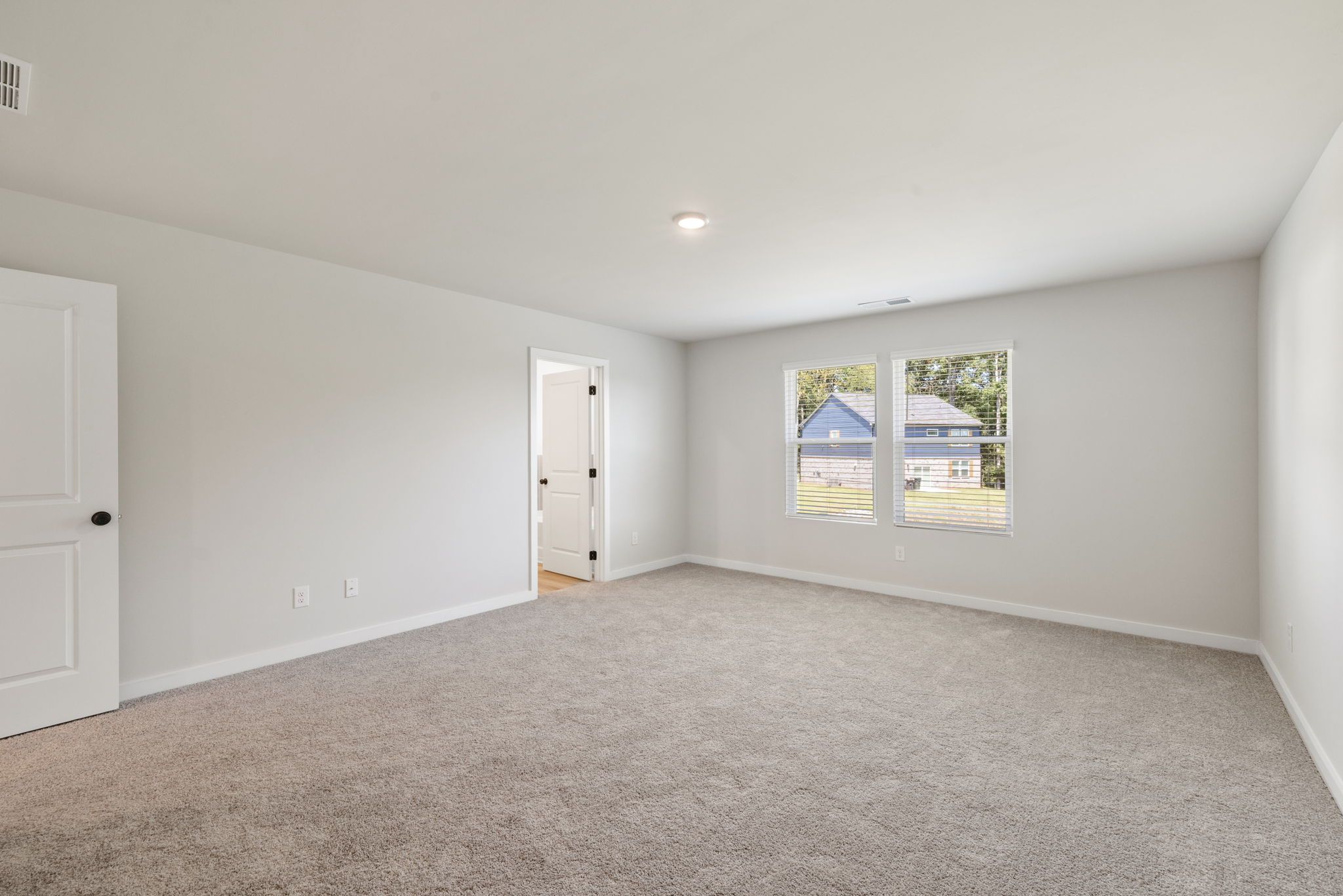 A room with a window and a door.