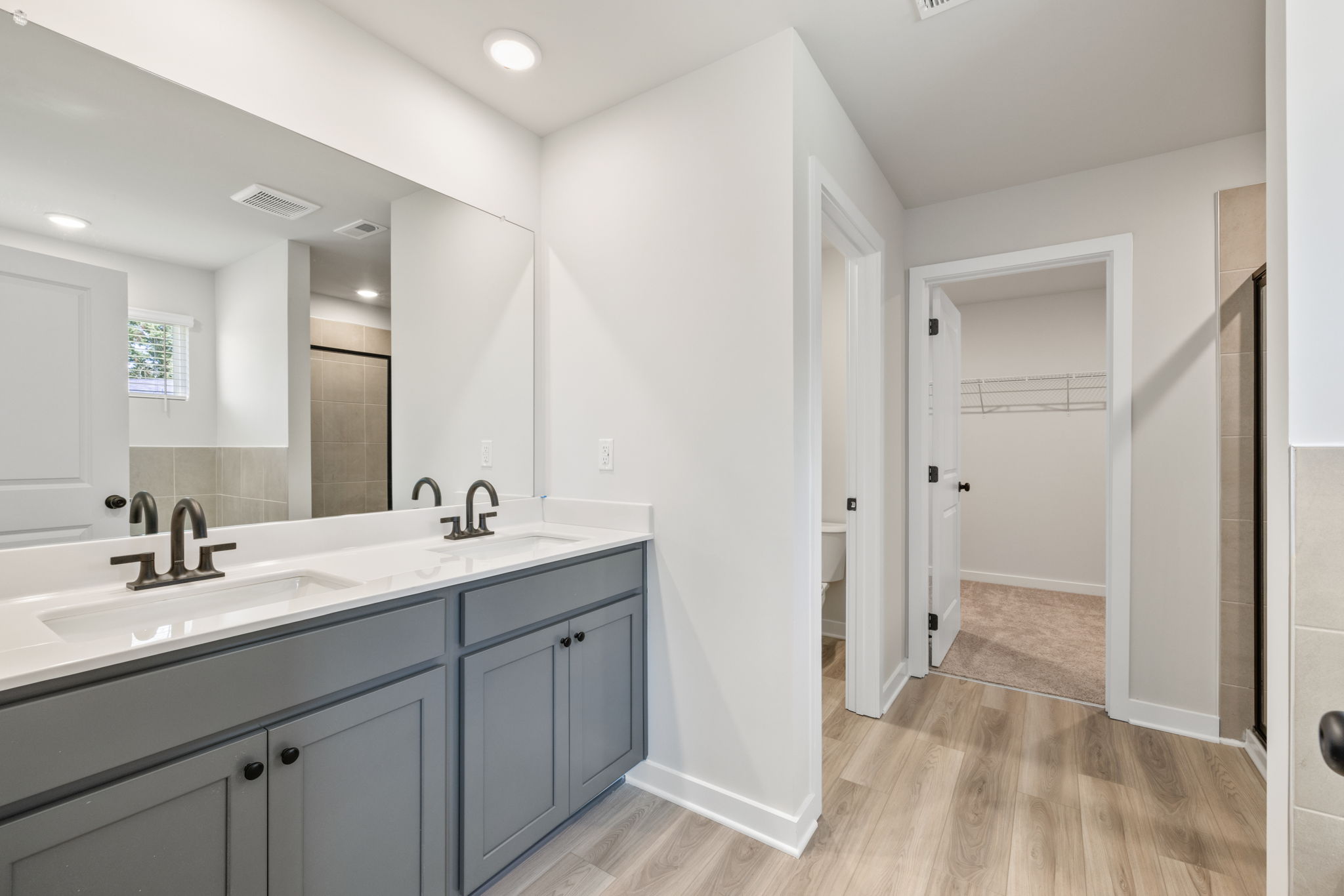 A bathroom with white cabinets.