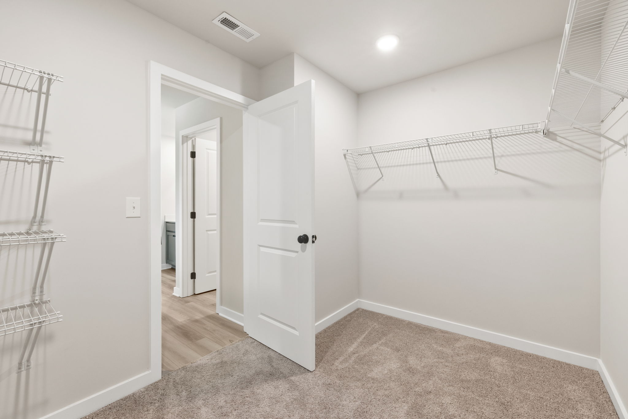 A room with white walls and a white door.