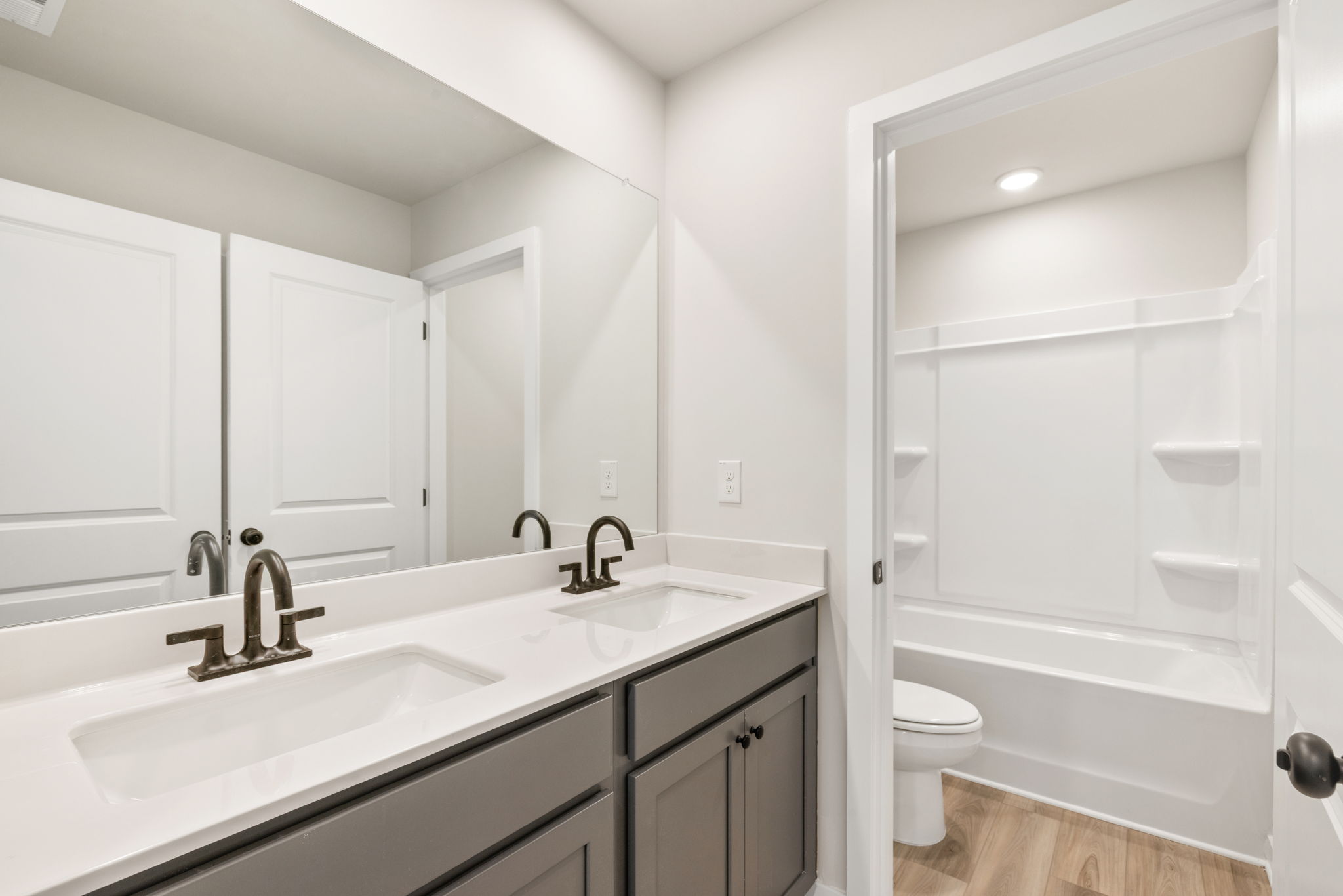 A bathroom with a sink toilet and bathtub.