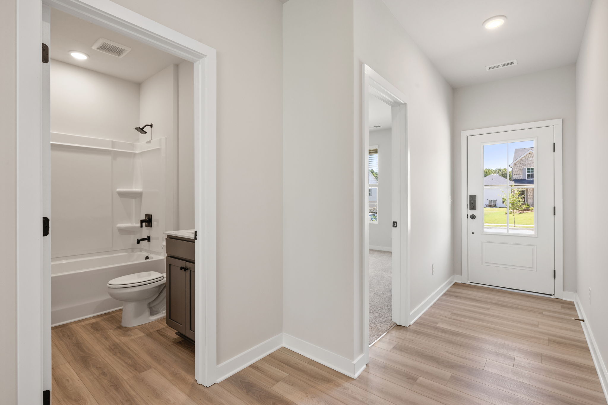 A bathroom with a wood floor.
