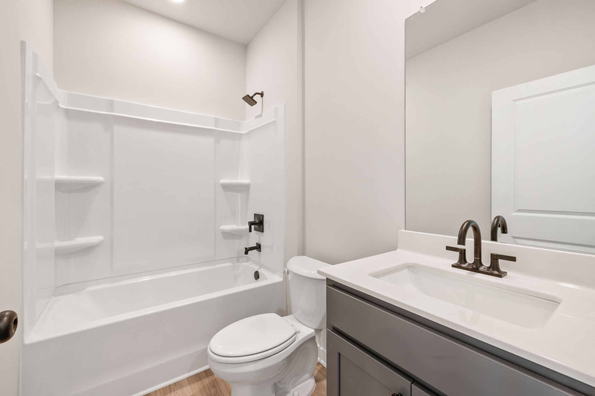 A bathroom with a sink toilet and bathtub.