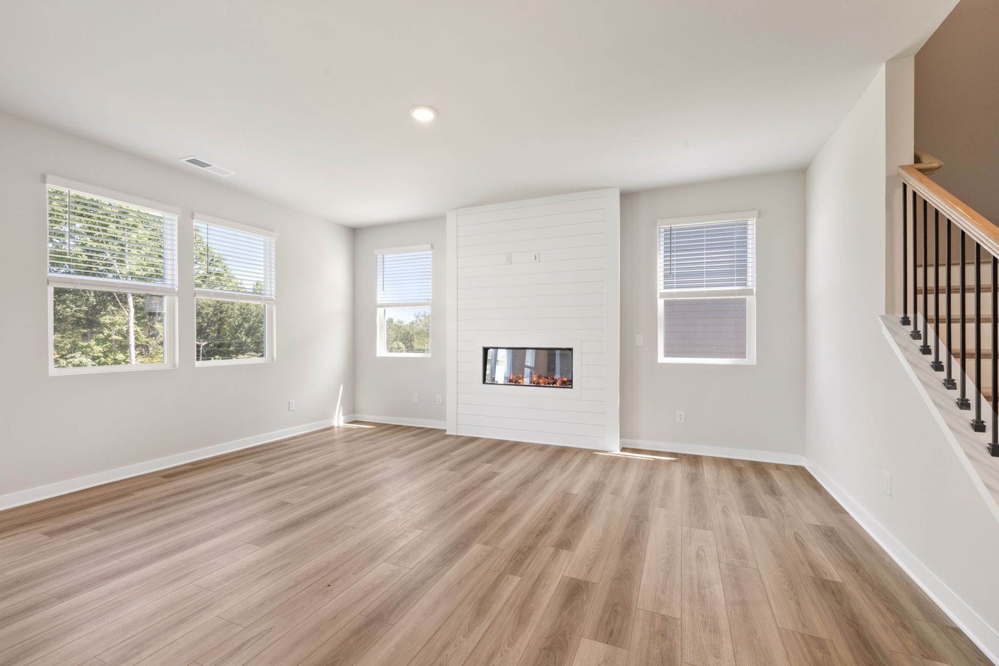 A room with a fireplace and a wood floor.