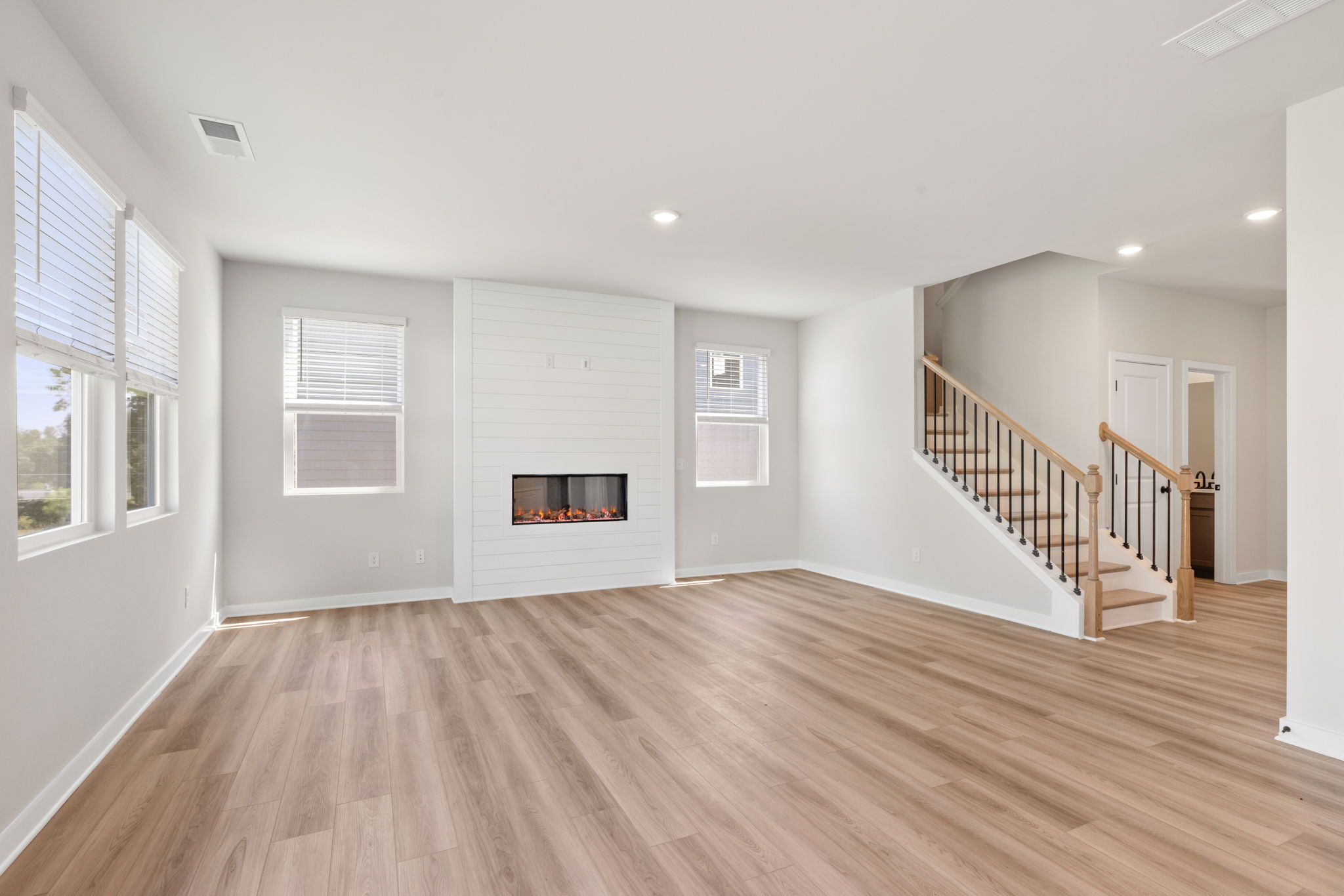 A room with a fireplace and a wood floor.