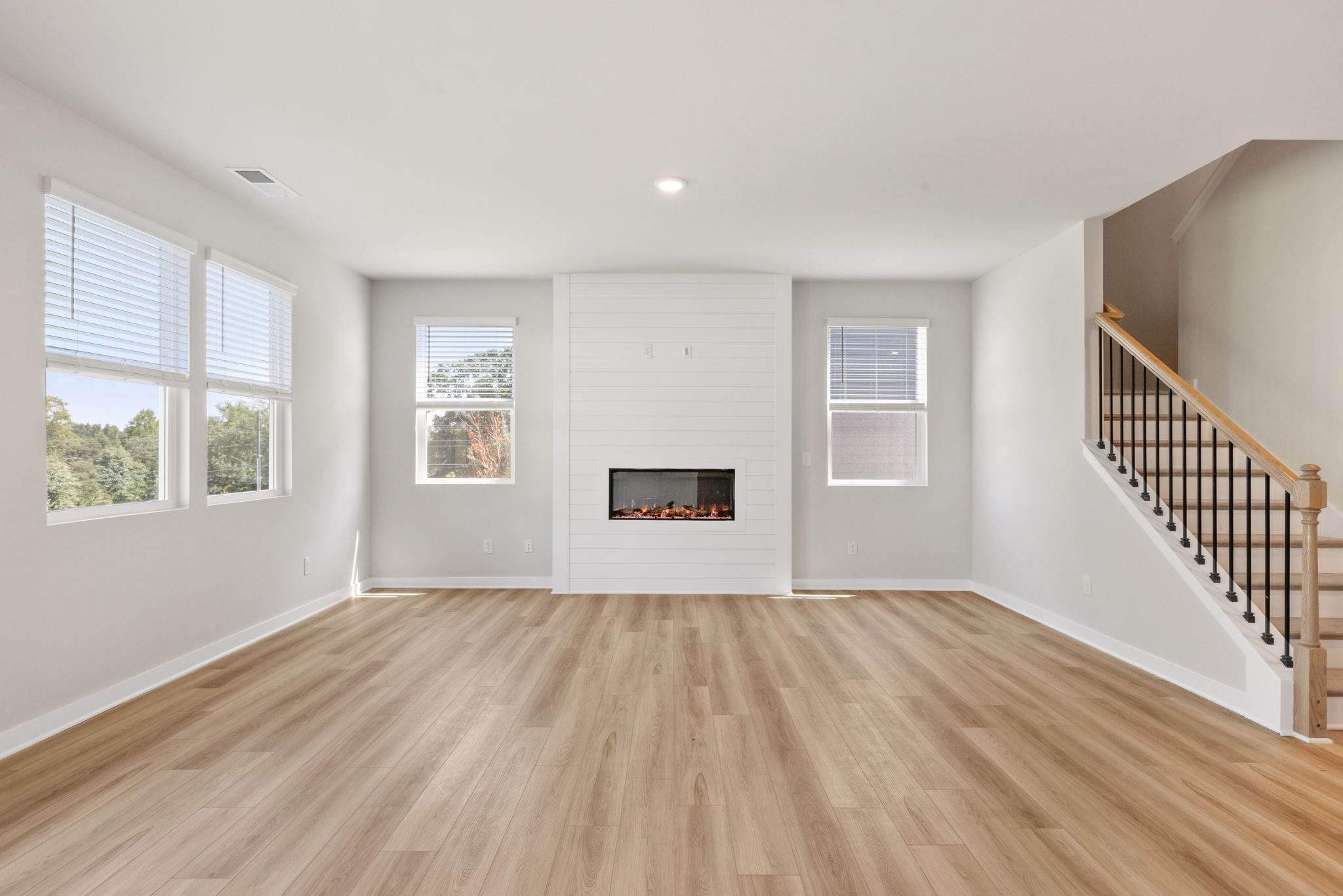 A room with a fireplace and a wood floor.
