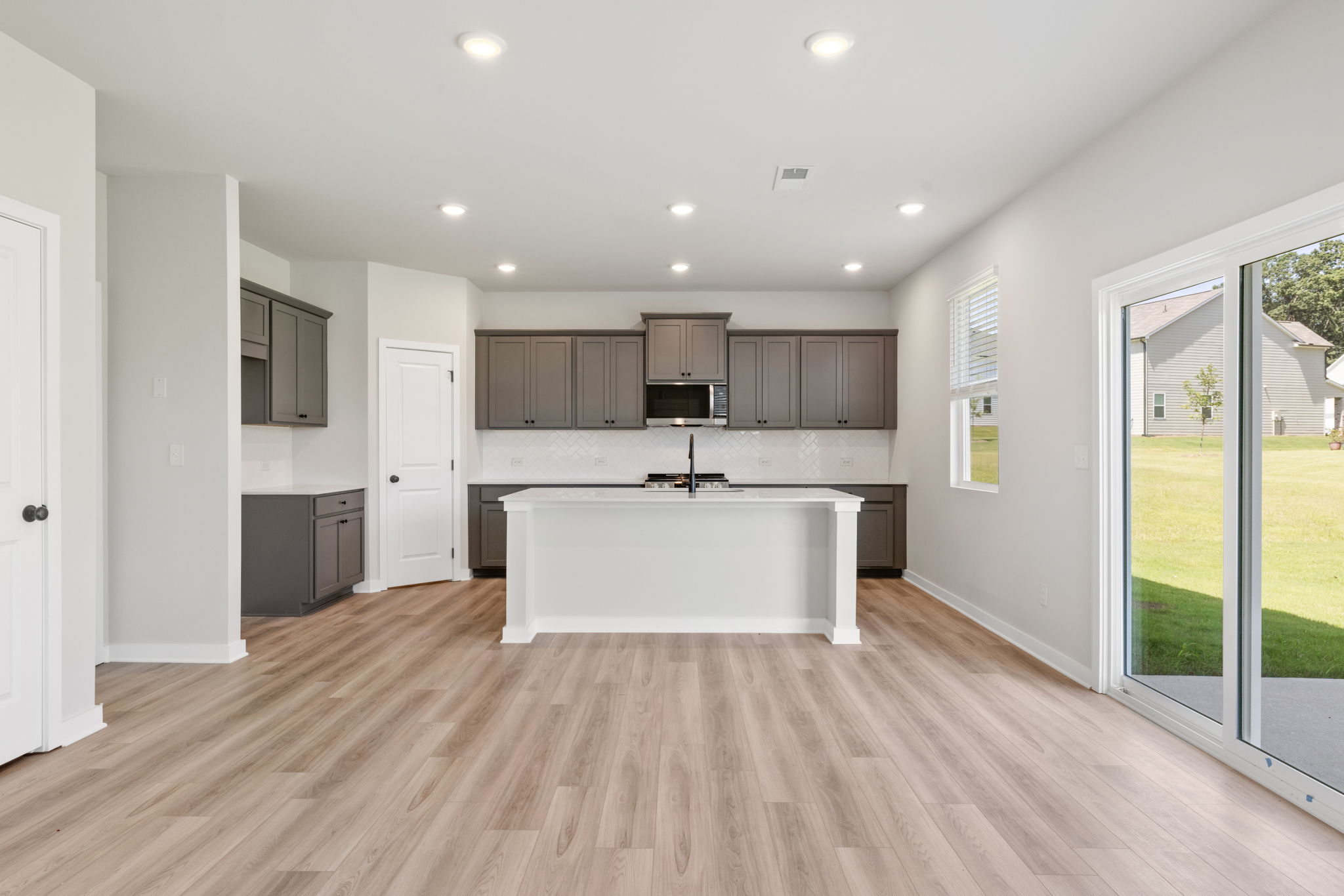 A kitchen with a large glass door.