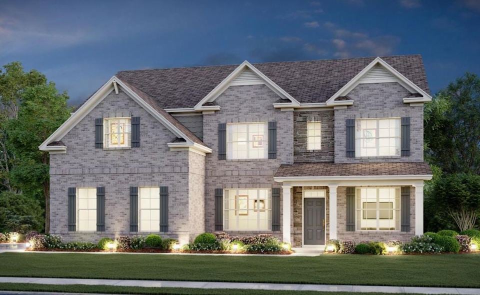 A large house with a lawn in front of it.