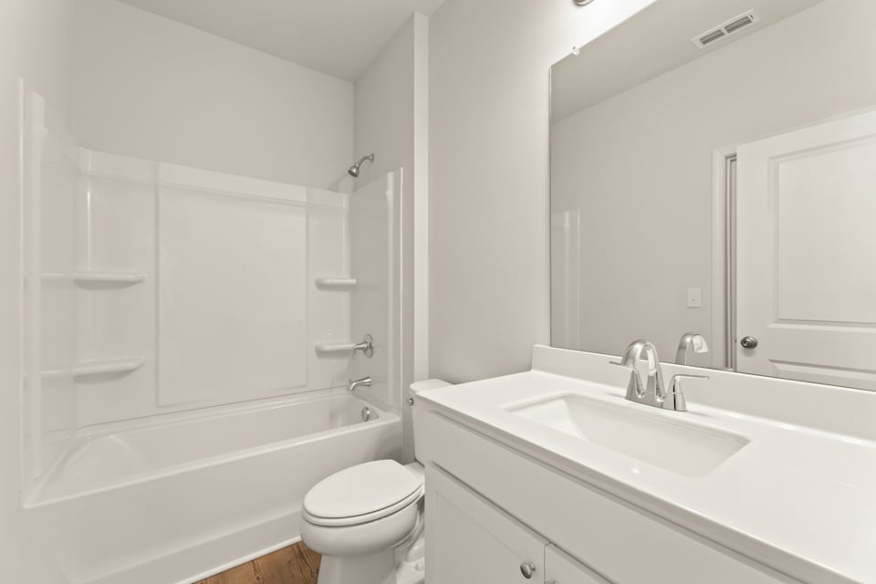 A bathroom with a tub sink and toilet.