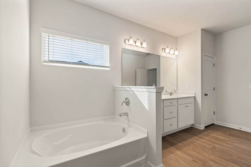A bathroom with a tub and sink.